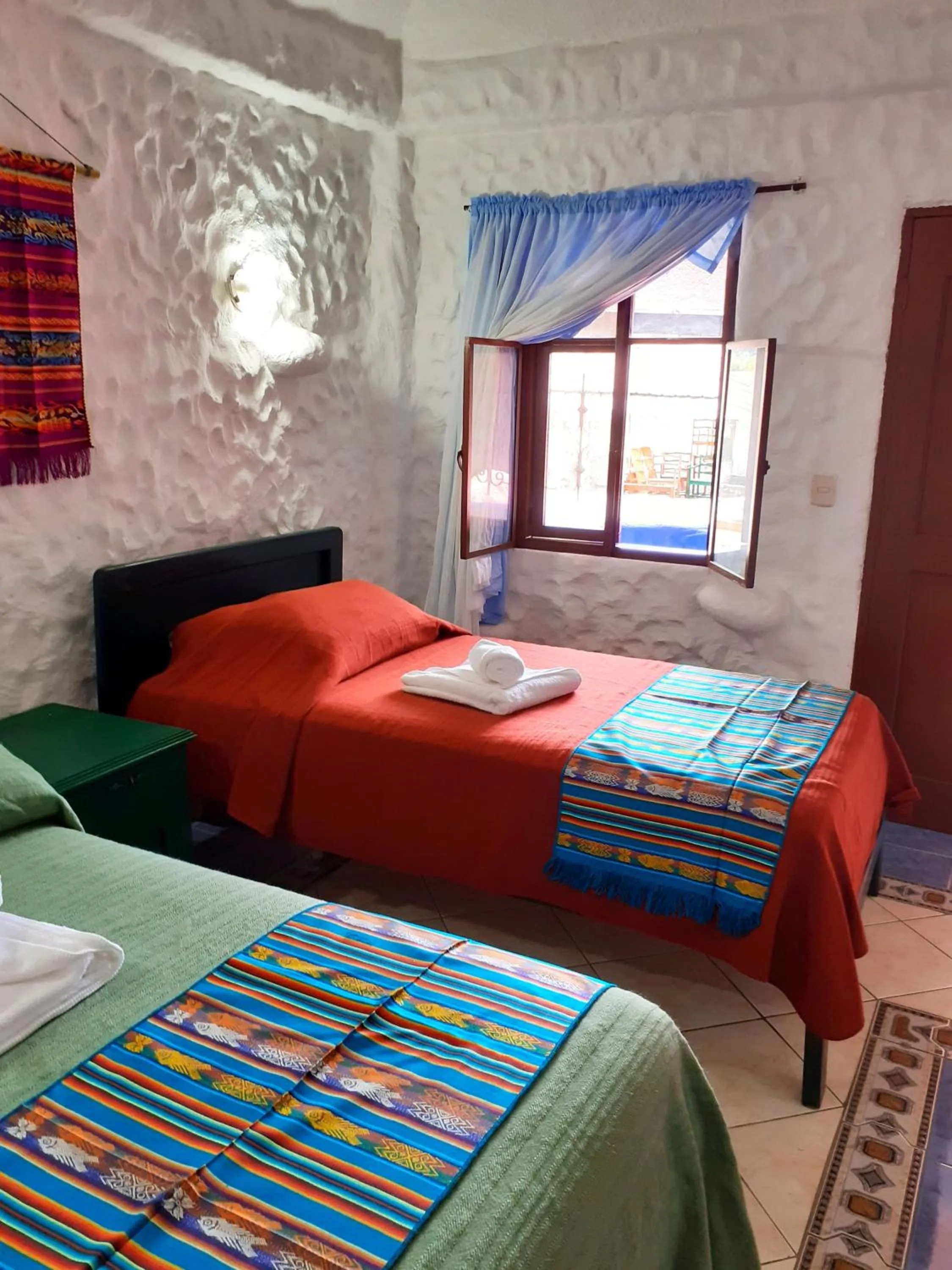 Bed in CasKaffeSu Hotel and Restaurant Mindo