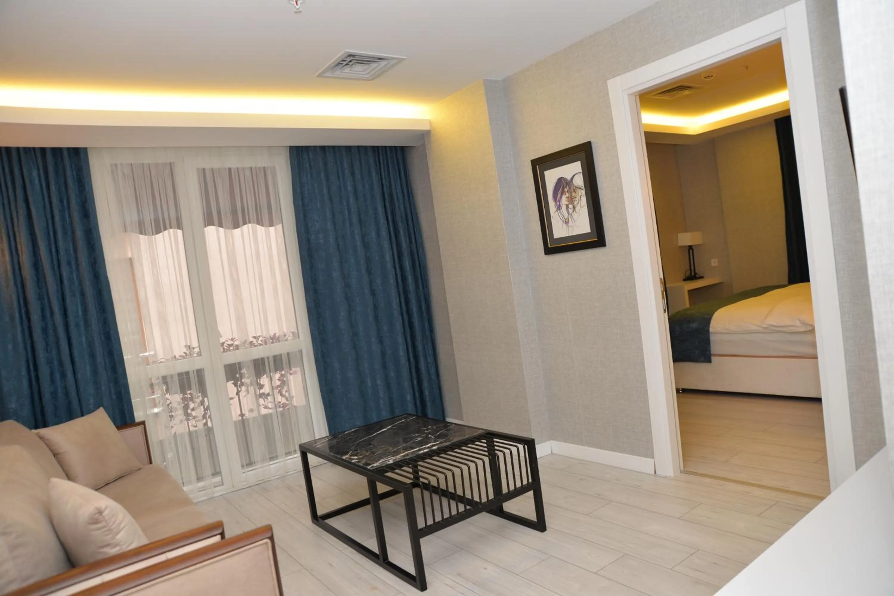 Living room, Bed in Gardenya Suite Hotel