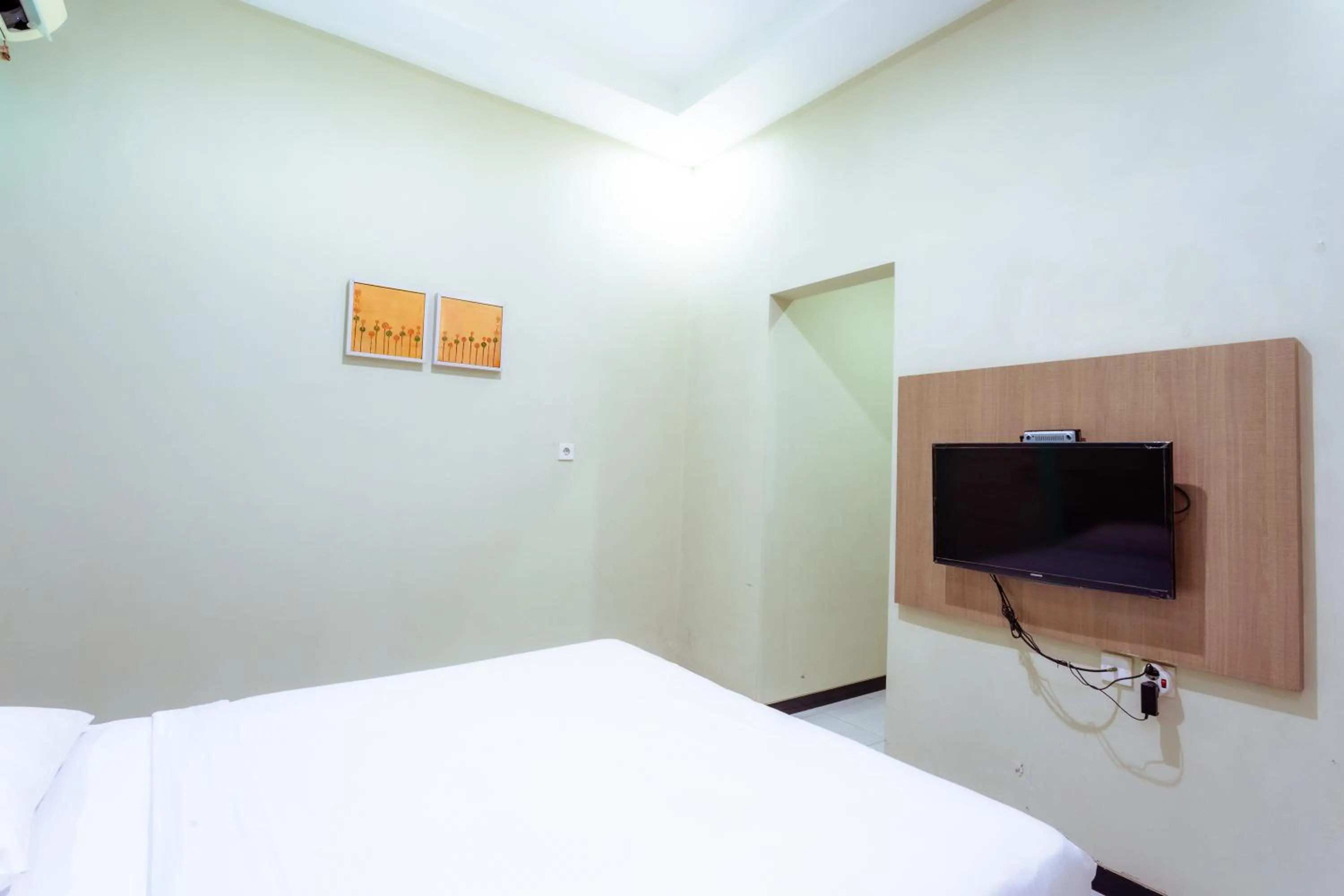 TV and multimedia, Bed in Ardhya Guesthouse Syariah by ecommerceloka