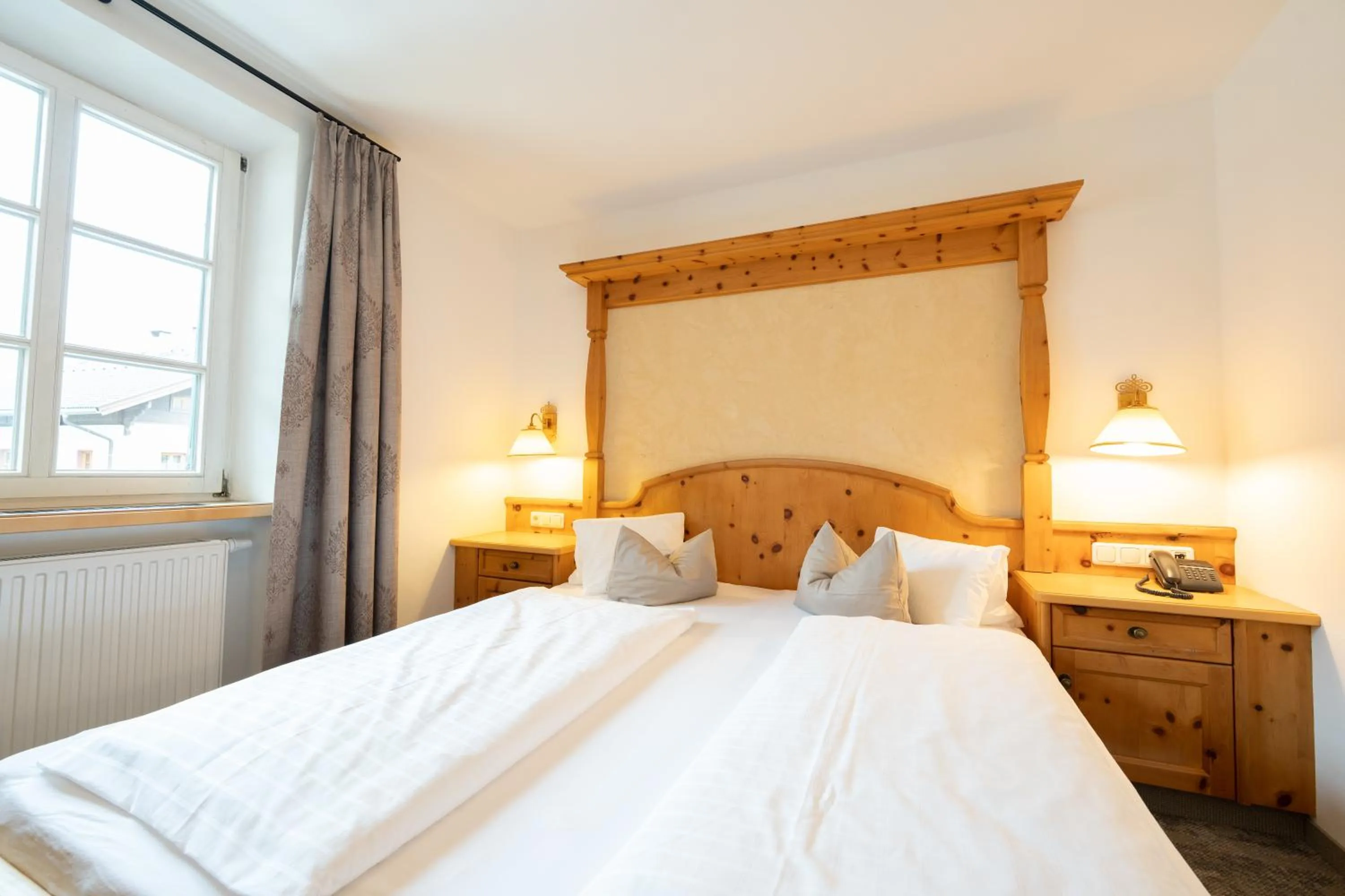 Bed in Alpenhotel Kramerwirt