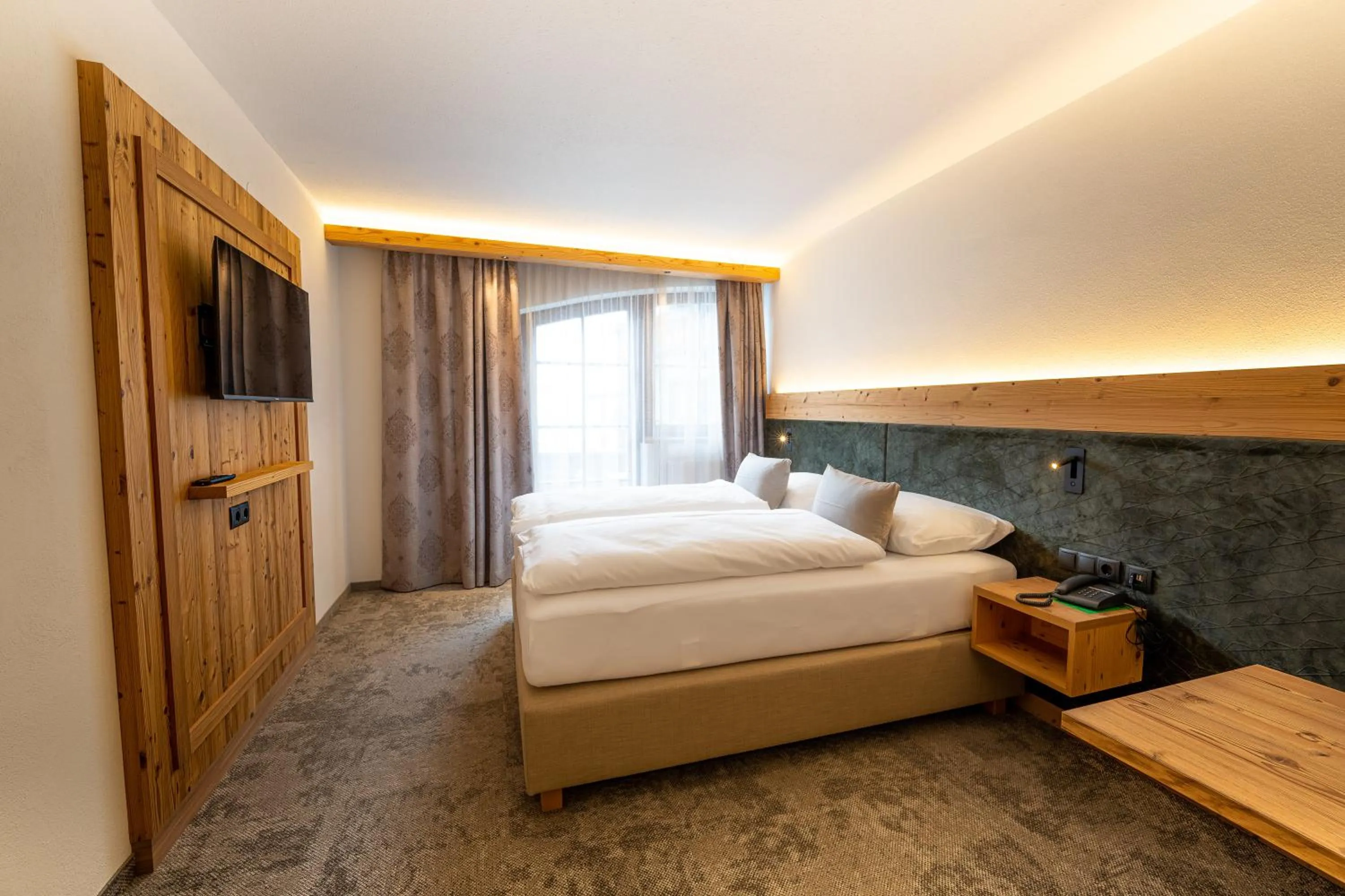 Bed in Alpenhotel Kramerwirt