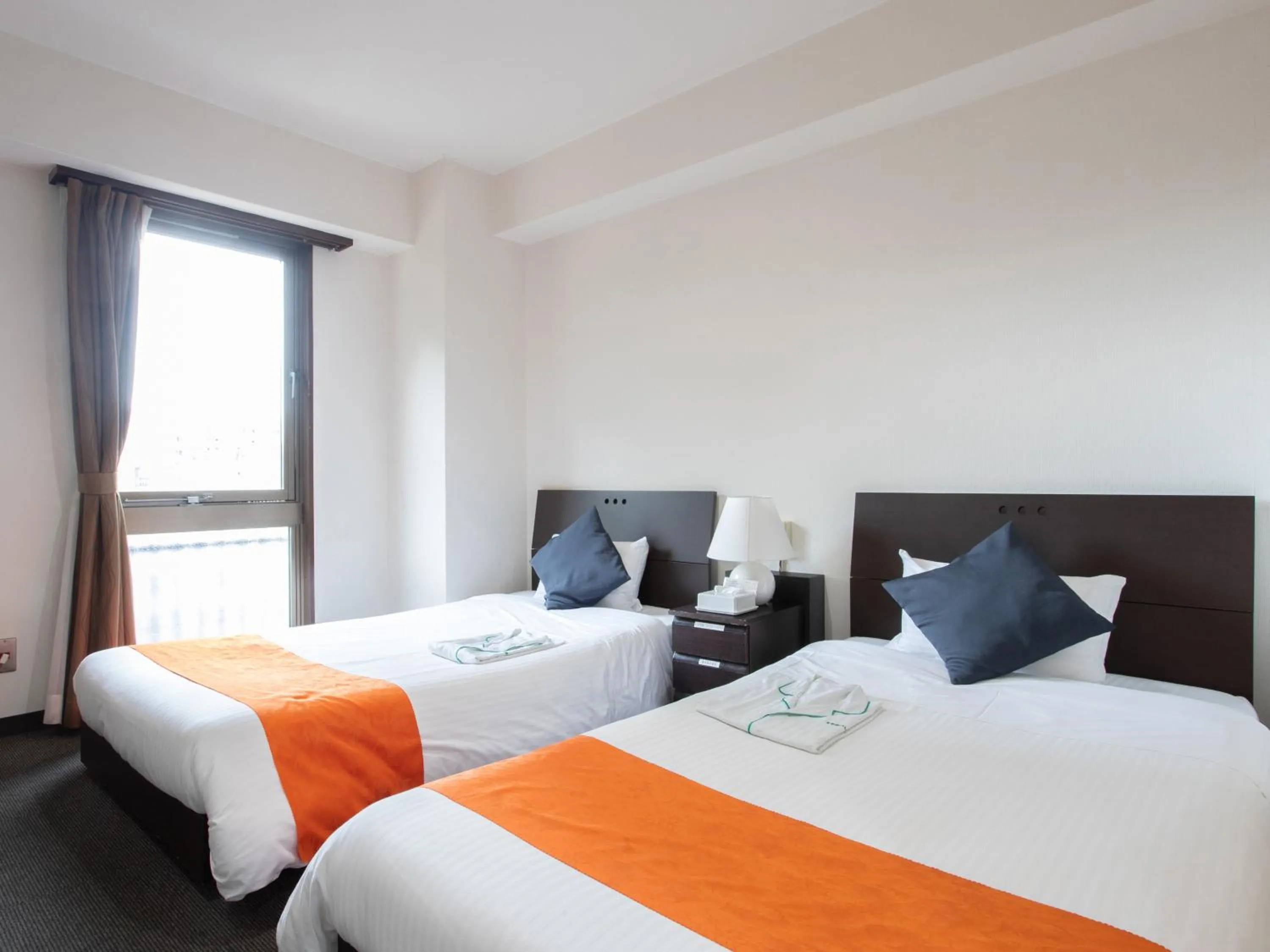 Bed in Tabist Sasebo Palace Hotel