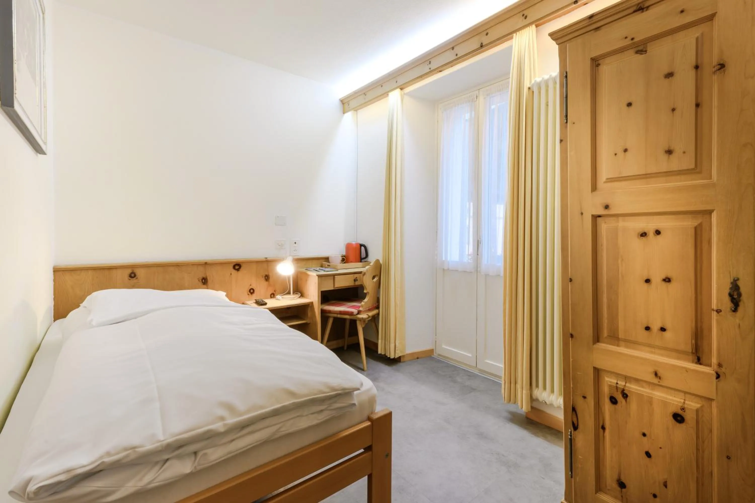 Bed in Poschiavo Suisse Hotel