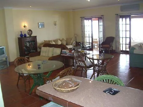 Communal lounge/ TV room in Las Flores Beachside Hotel