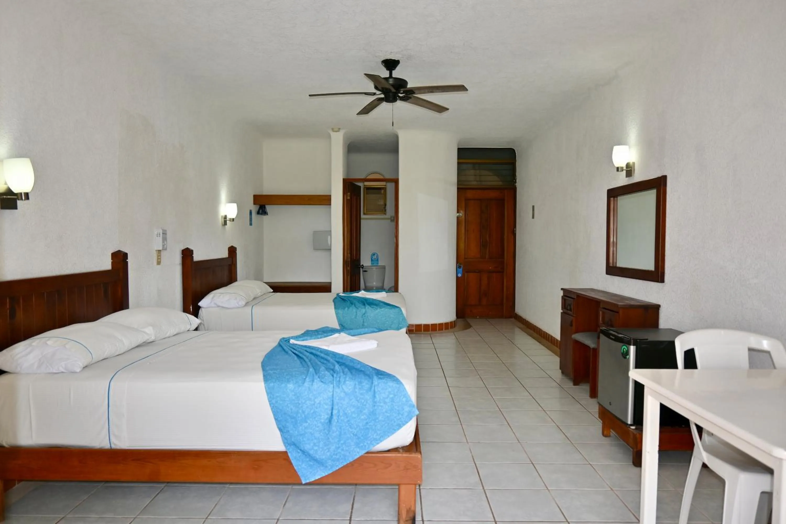 Bed in Pelicano Inn Playa del Carmen - Beachfront Hotel