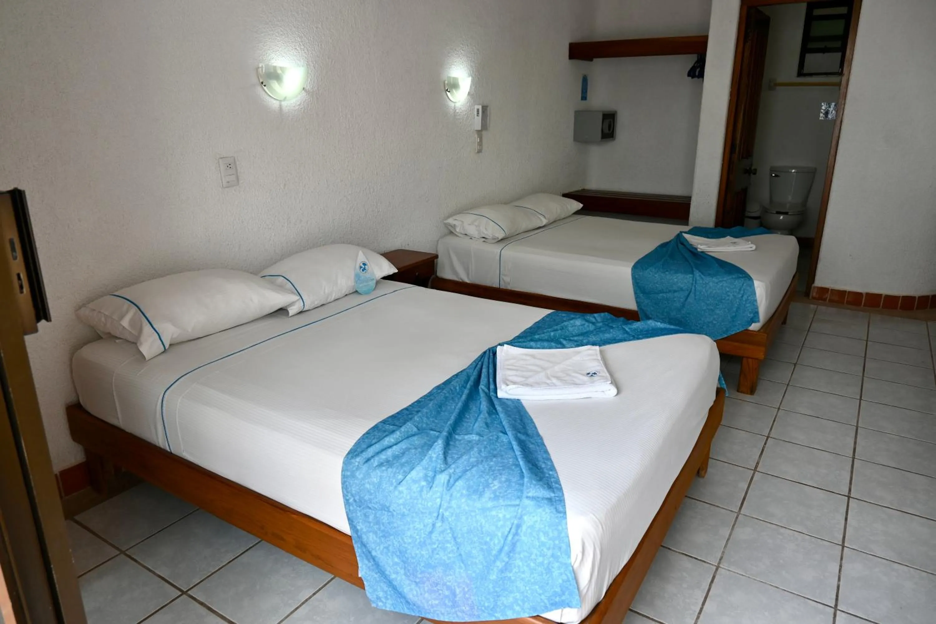 Bed in Pelicano Inn Playa del Carmen - Beachfront Hotel