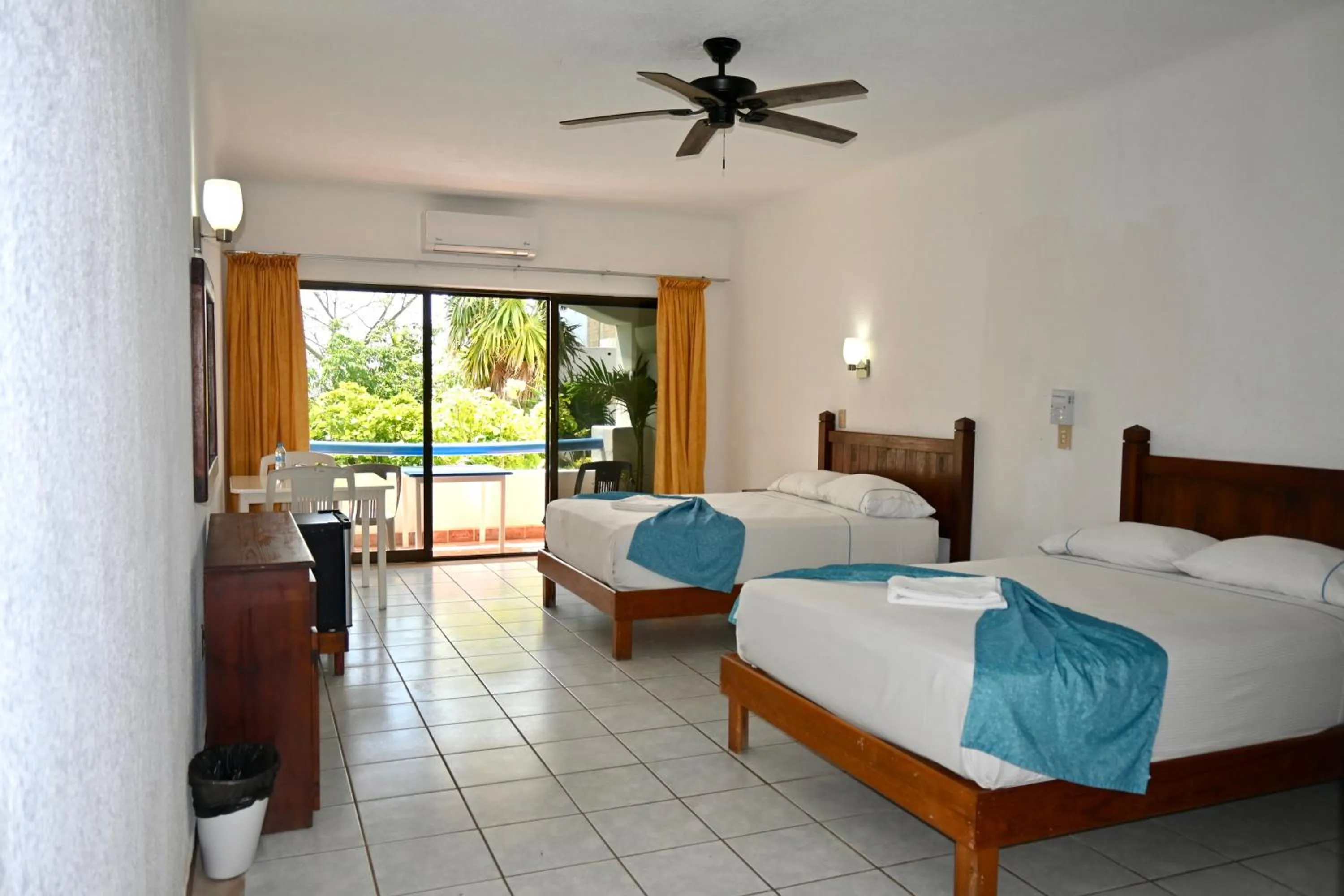 Bed in Pelicano Inn Playa del Carmen - Beachfront Hotel