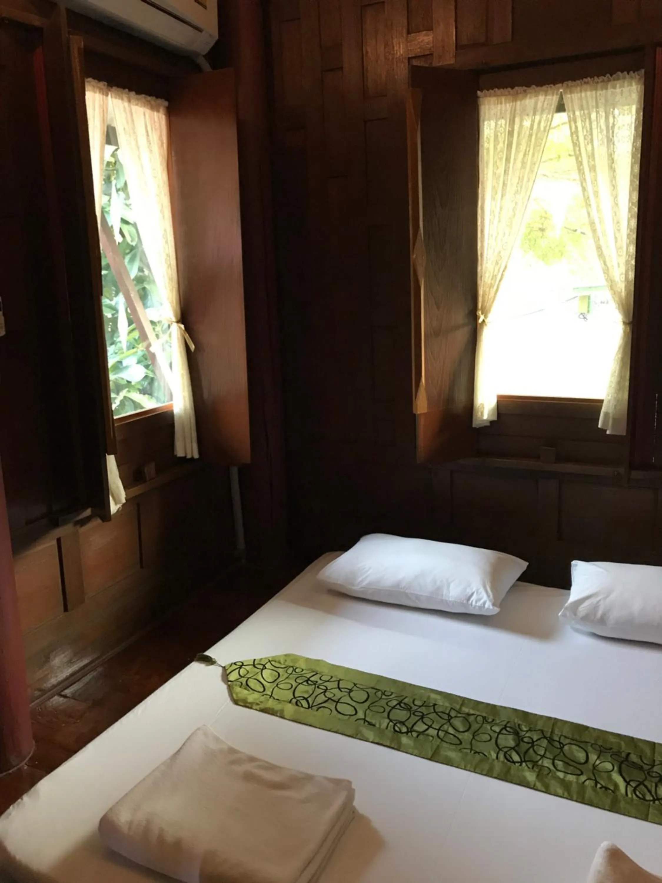 Bed in บ้านกรนรา Baan Kornnara