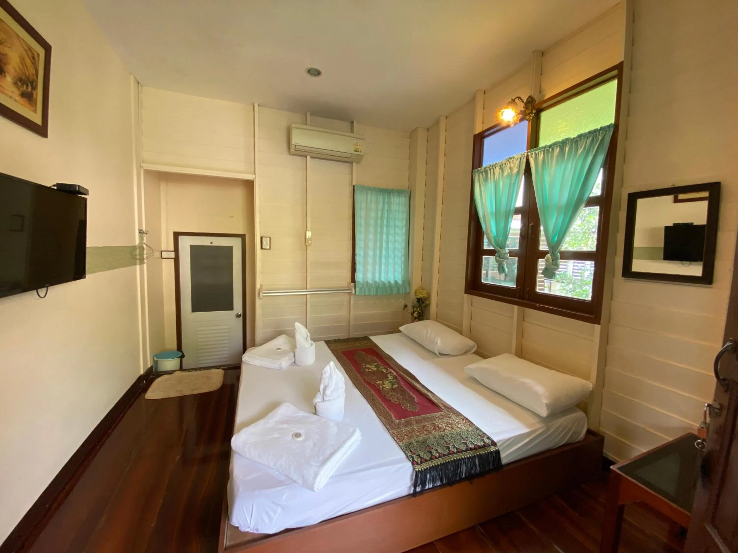 Bed in บ้านกรนรา Baan Kornnara