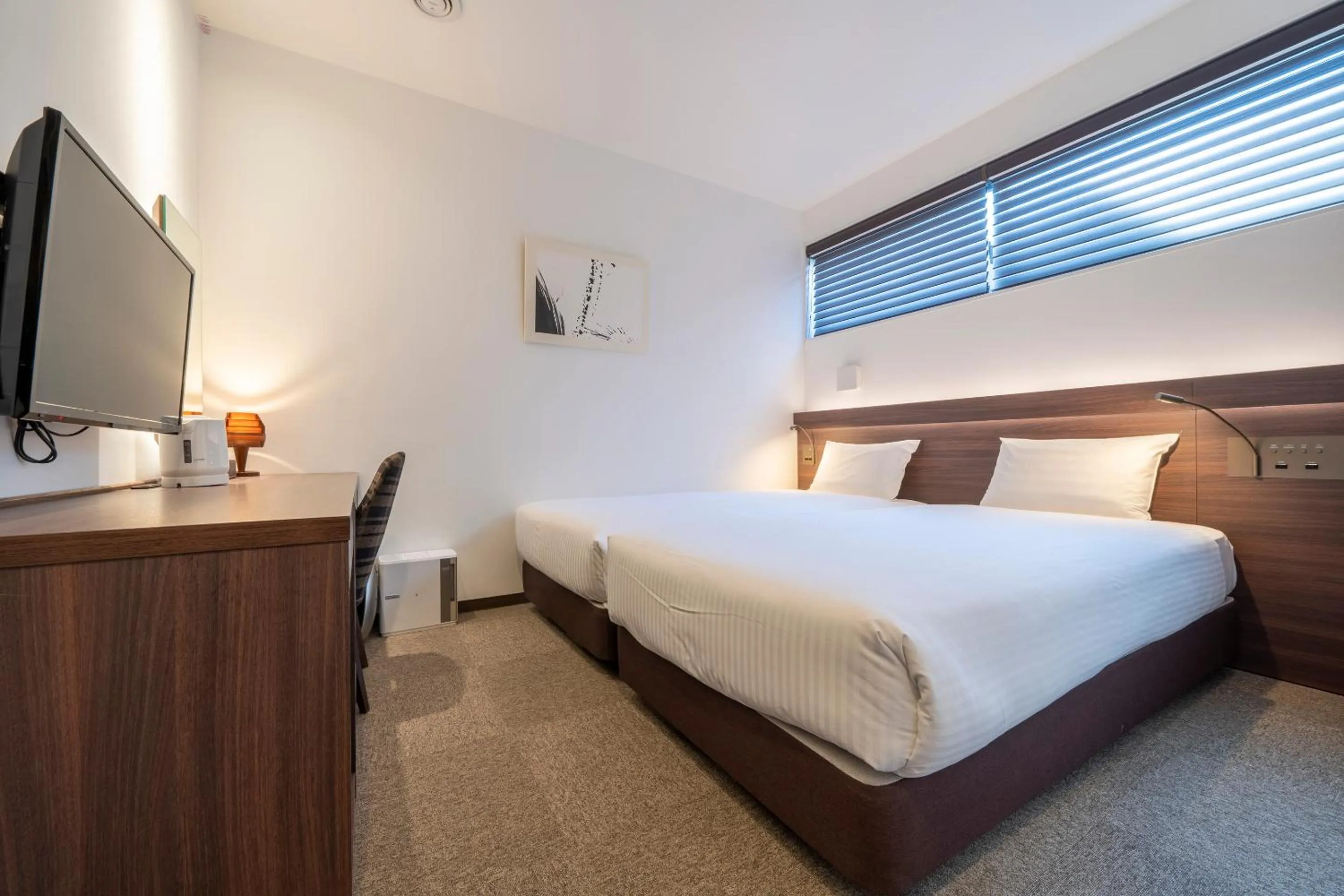 Bed in RESI STAY Jisco Hotel Kyoto Goshonishi