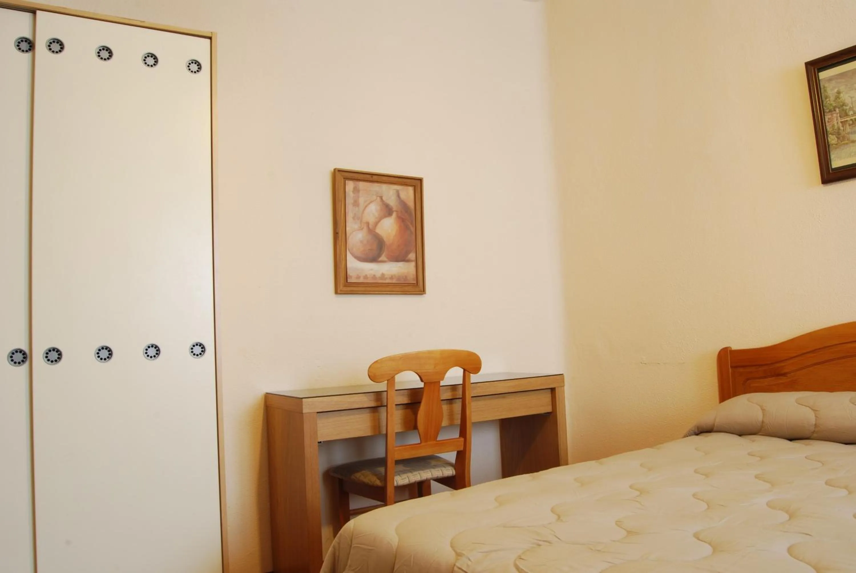 Seating area, Bed in Hostal America