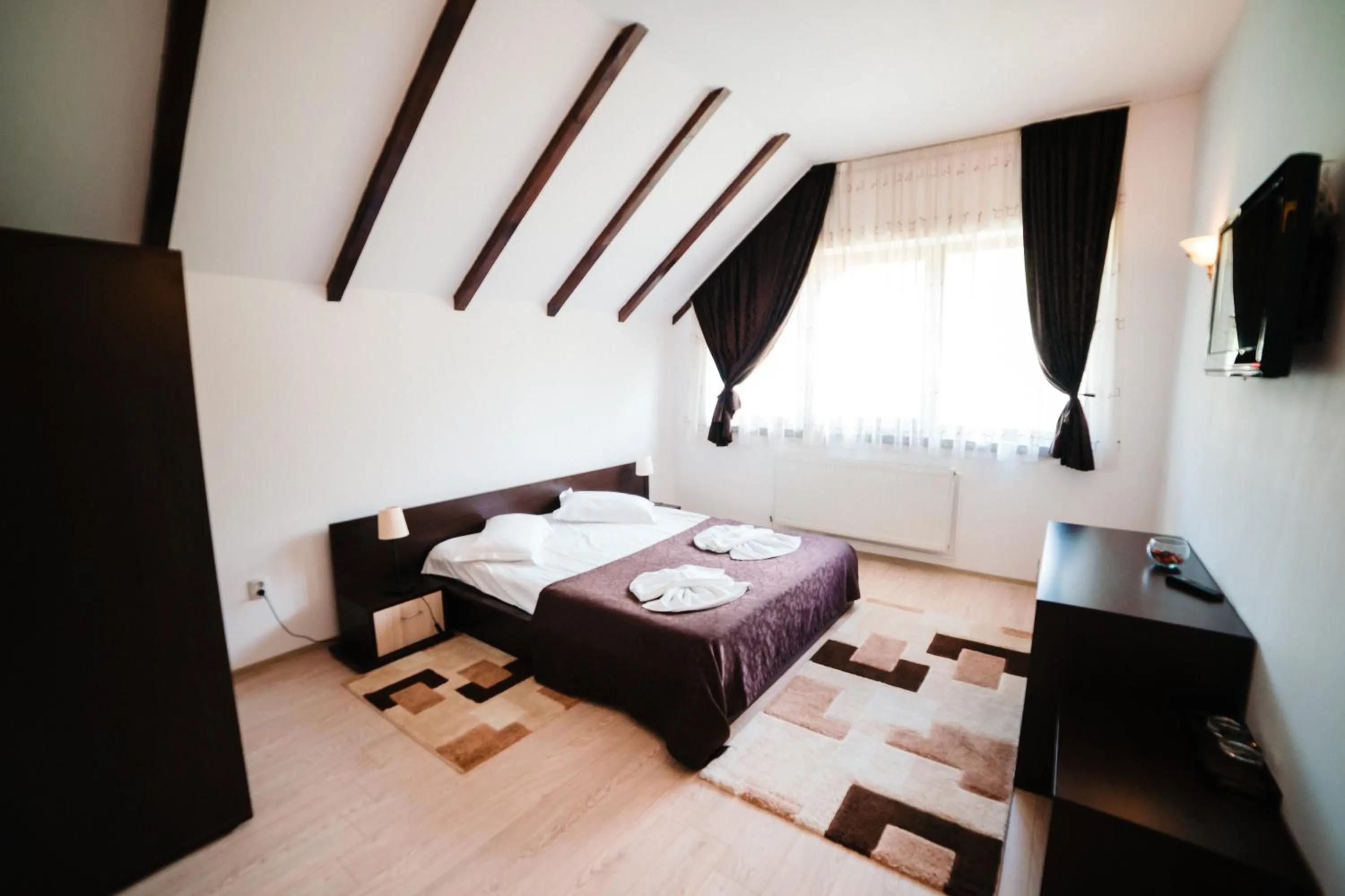 Photo of the whole room, Bed in Hotel boutique Garden Resort by Brancoveanu