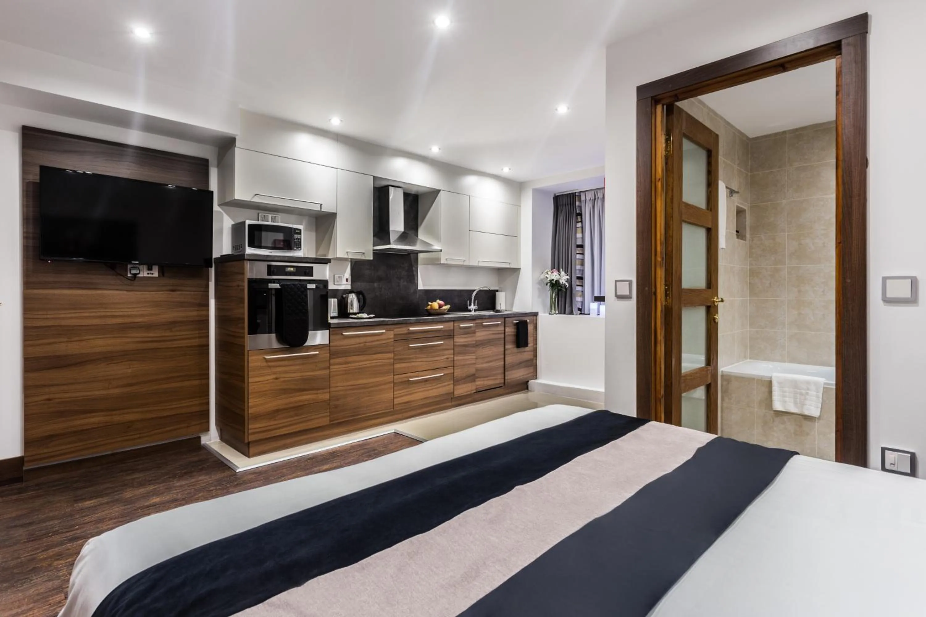 Kitchen or kitchenette, Bed in Livin' Serviced Apartments