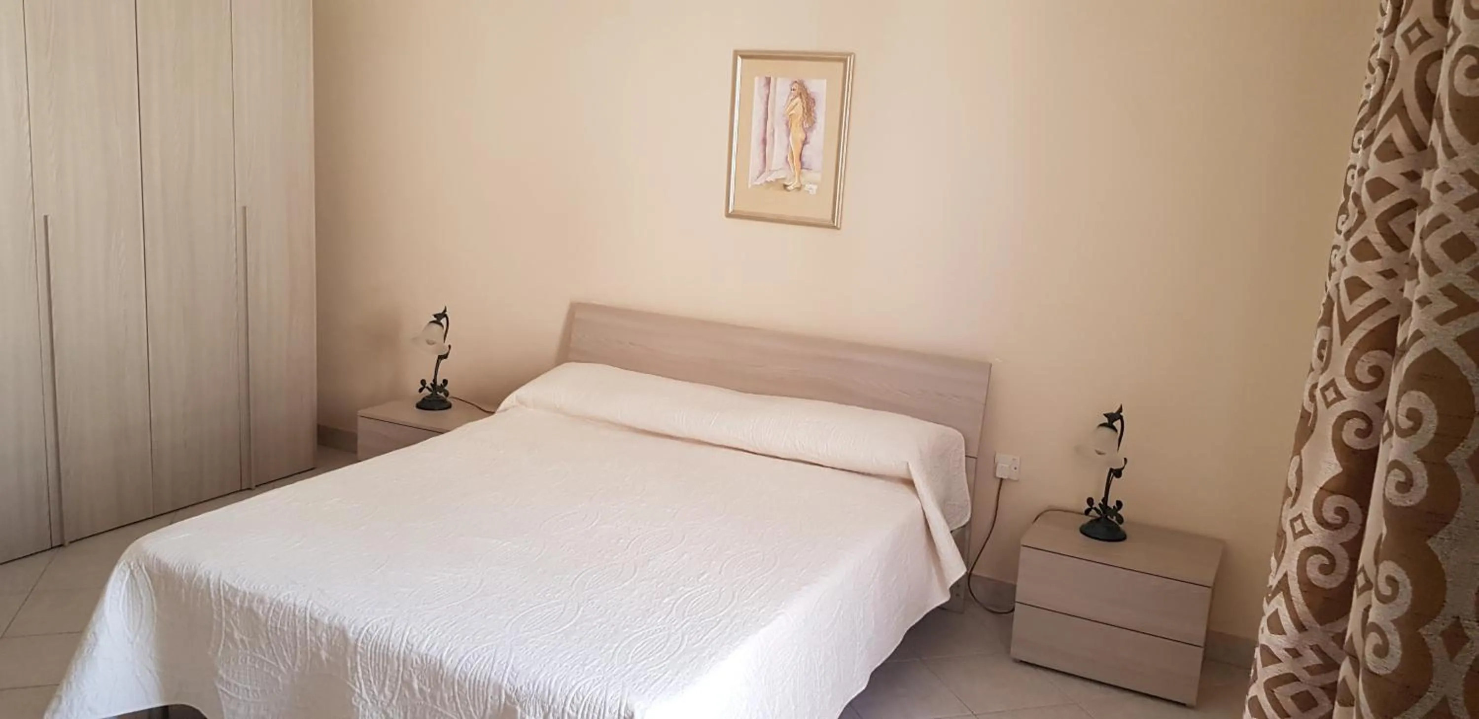 Bed in Aurora Apartment