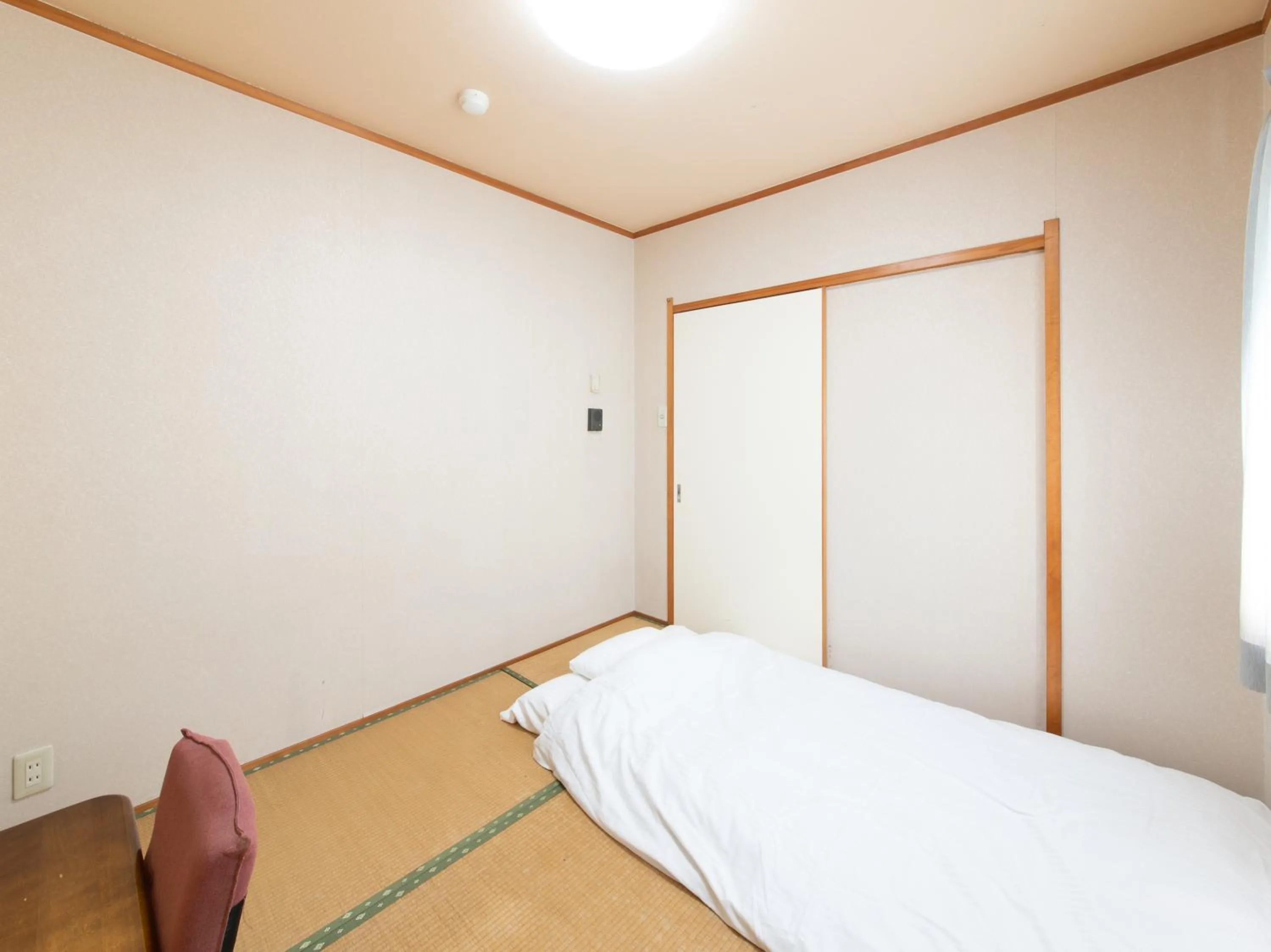 Bed in Tabist Tatsumi Business Hotel Matsusaka