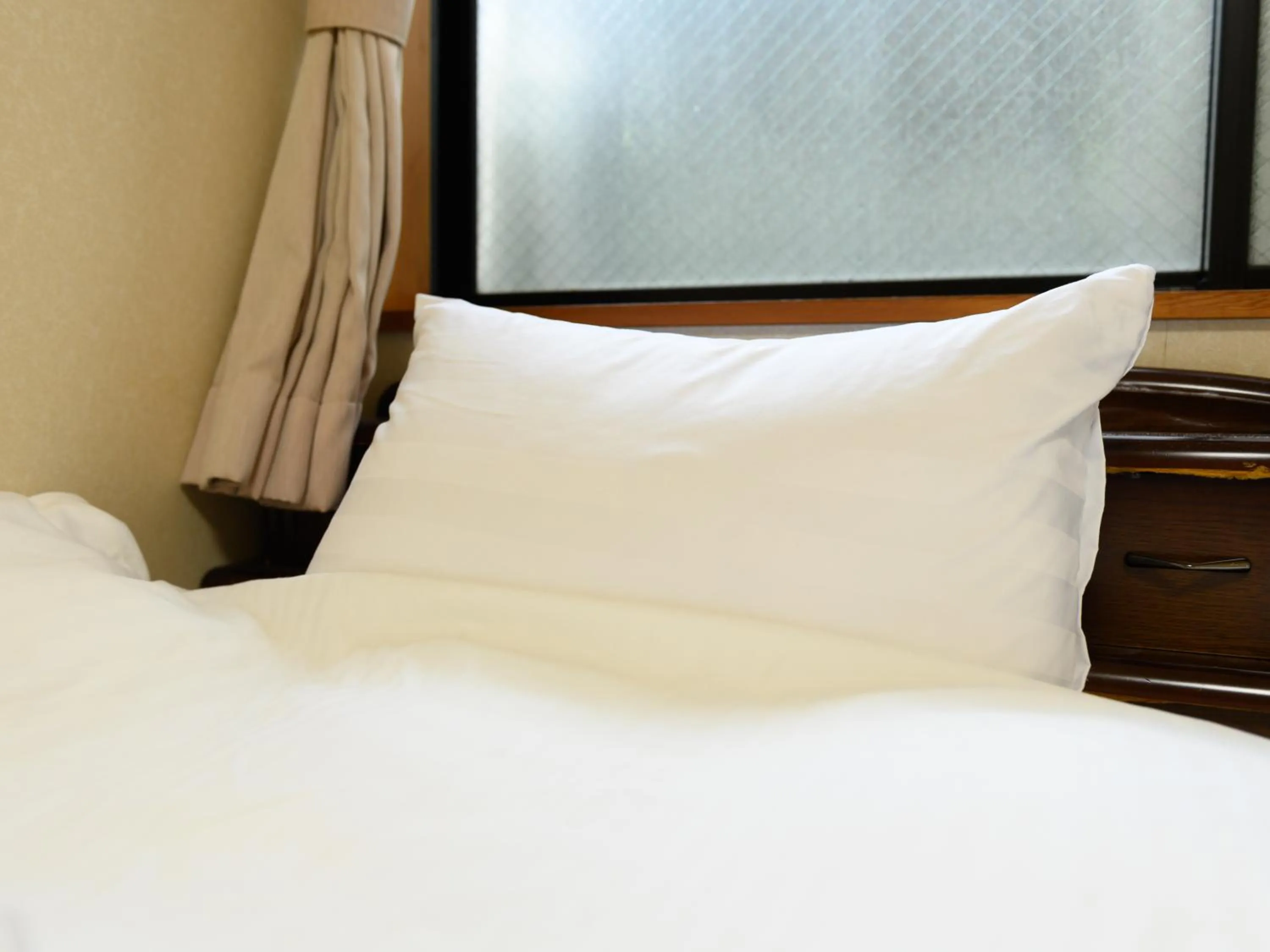 Bed in Tabist Tatsumi Business Hotel Matsusaka