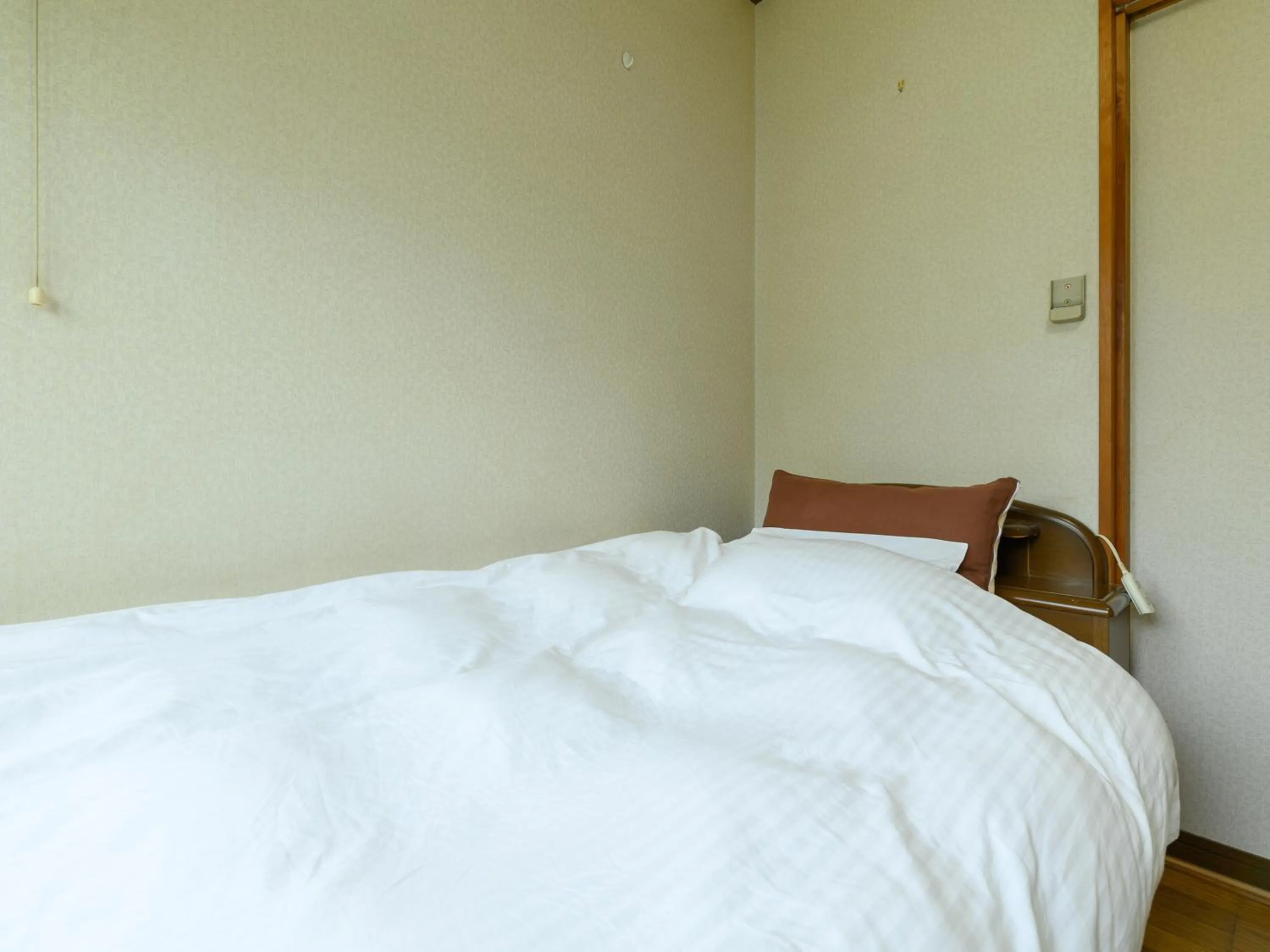 Bed in Tabist Tatsumi Business Hotel Matsusaka