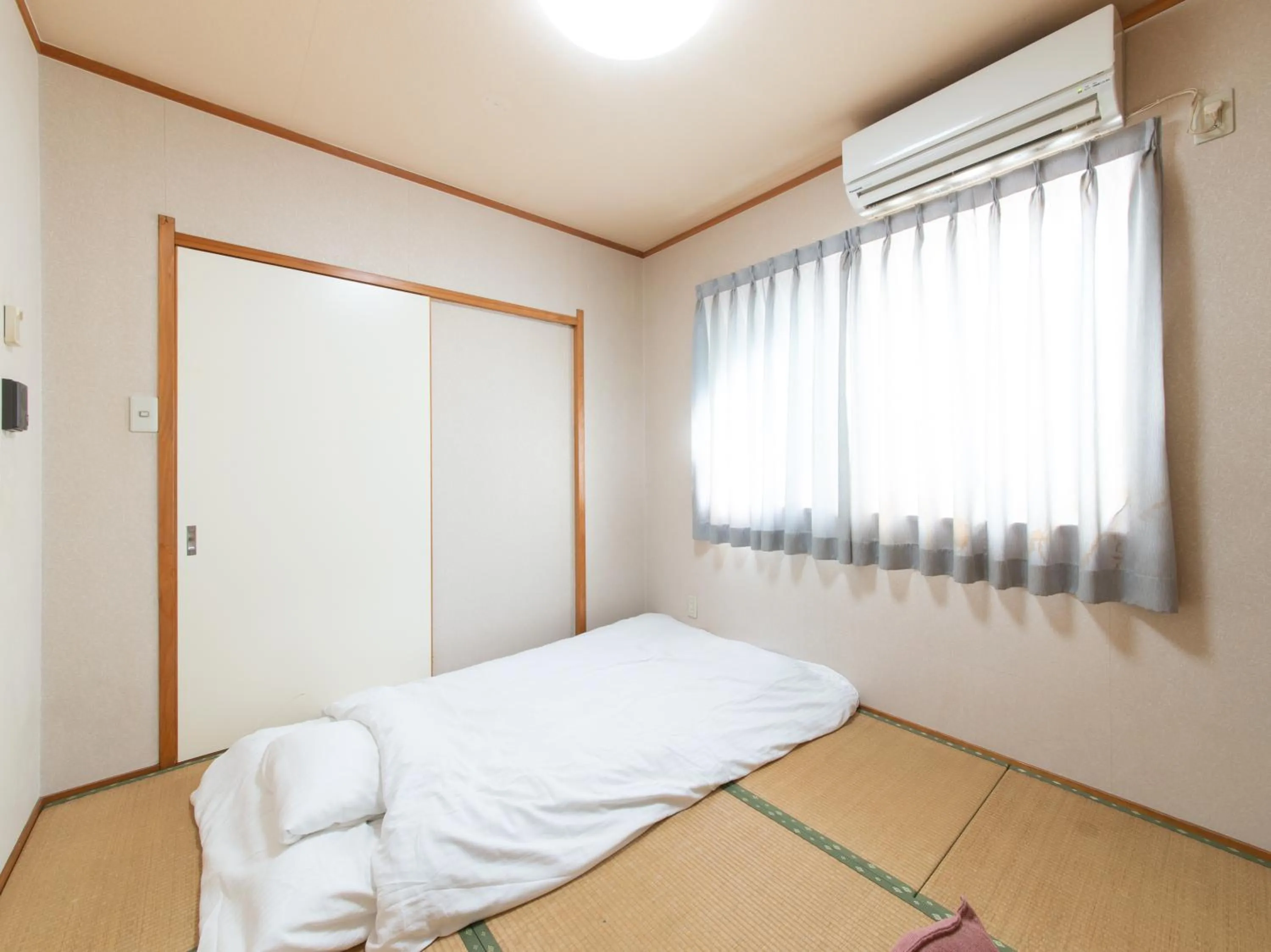 Bed in Tabist Tatsumi Business Hotel Matsusaka