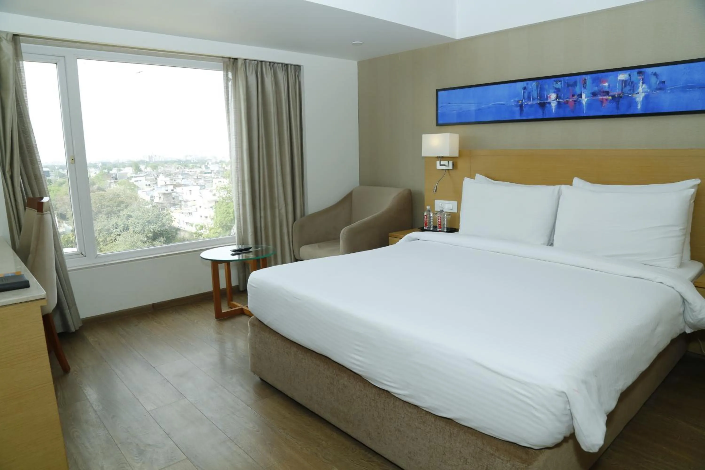 Bed in Sarovar Portico Rivera Ahmedabad