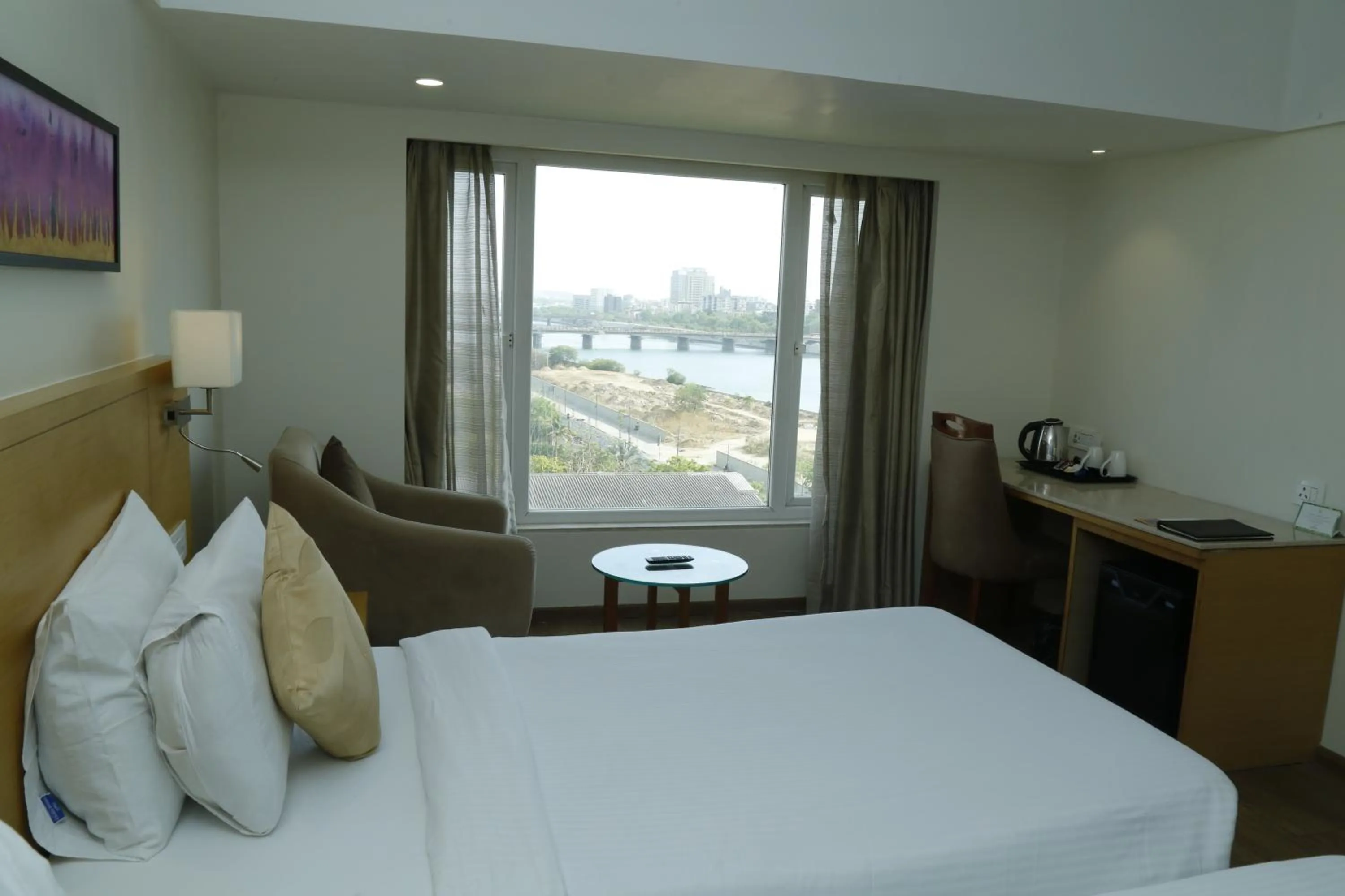 Bed in Sarovar Portico Rivera Ahmedabad