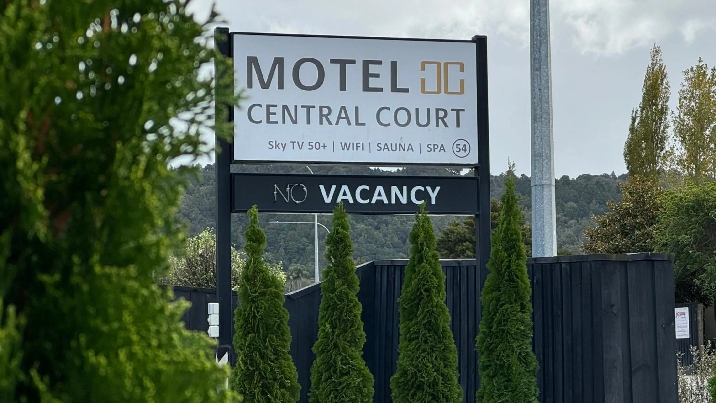 Property logo or sign in Central Court Motel