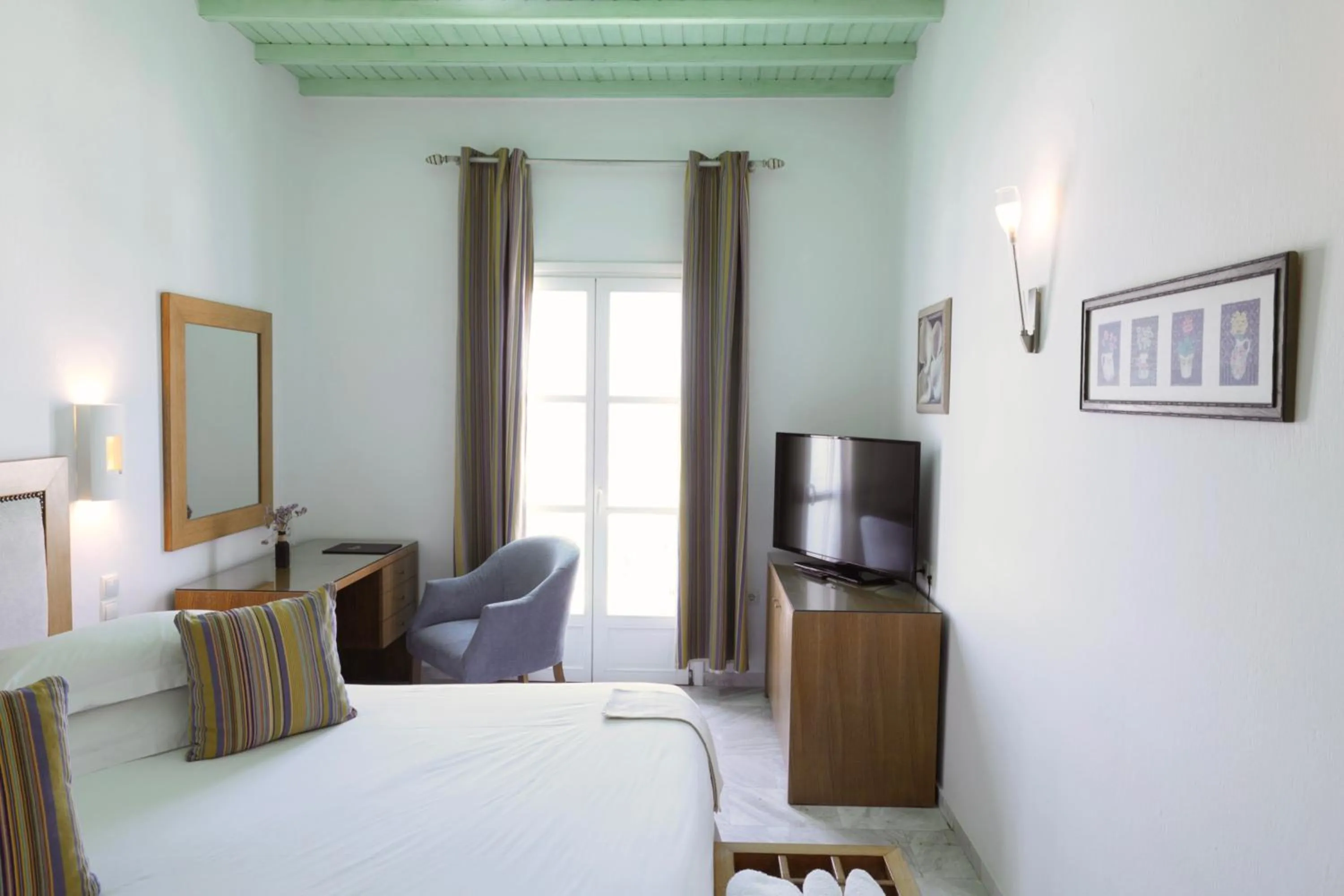 Bed in Poseidon Hotel Suites