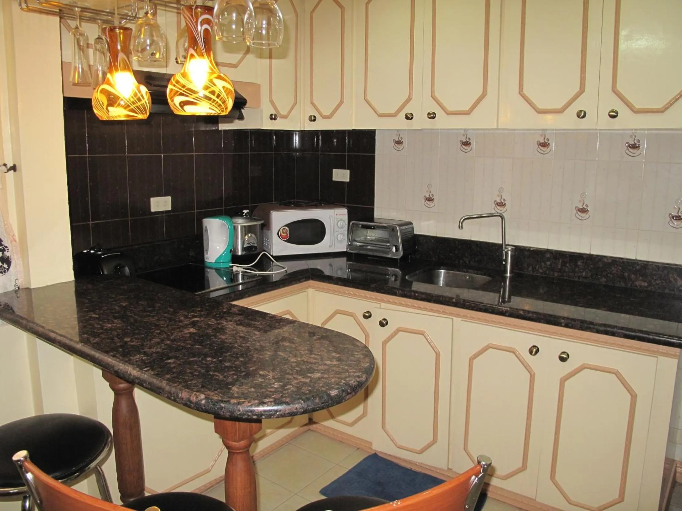 Kitchen or kitchenette in Makati Suites at Travelers Inn