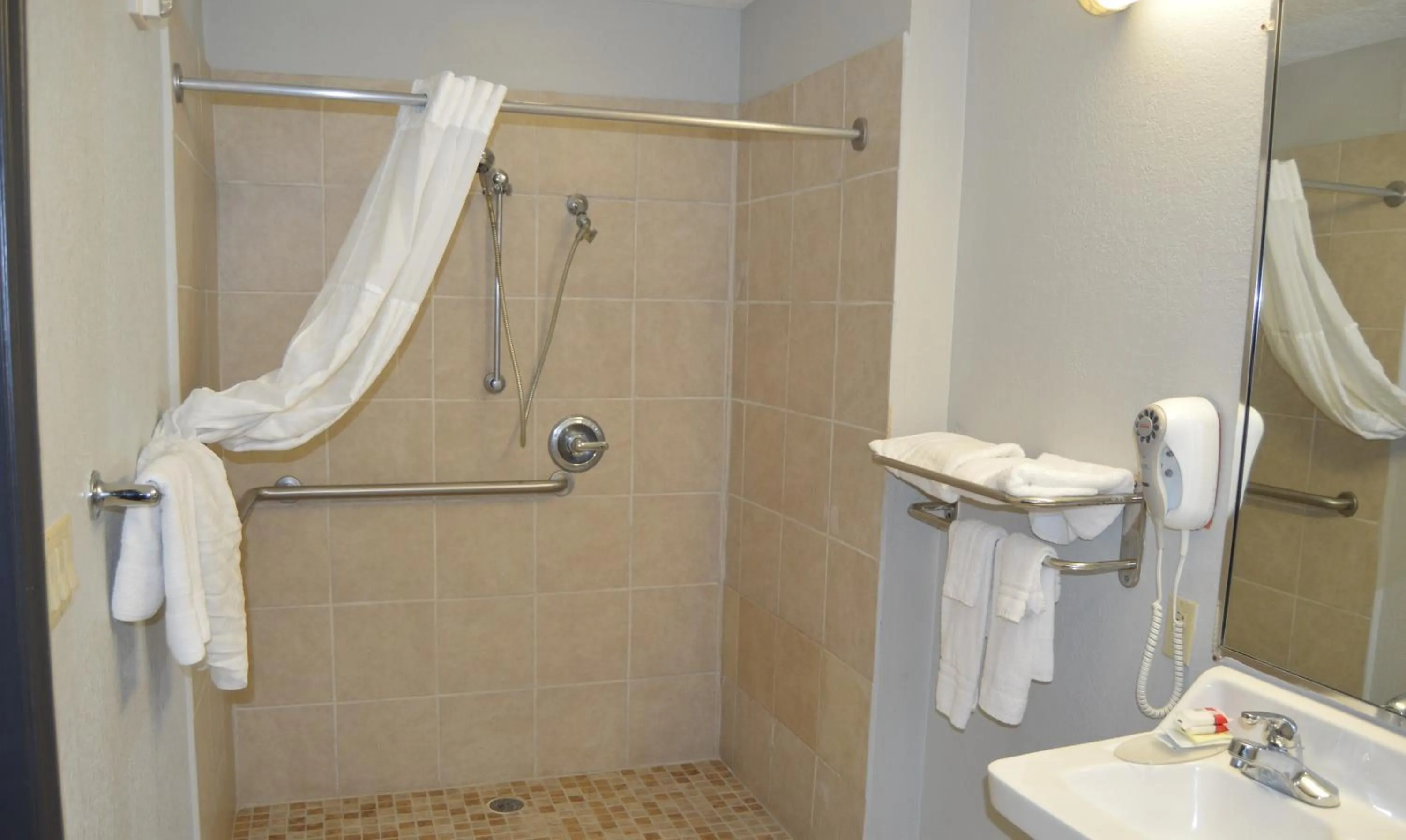 Bathroom in Days Inn & Suites by Wyndham Winnie