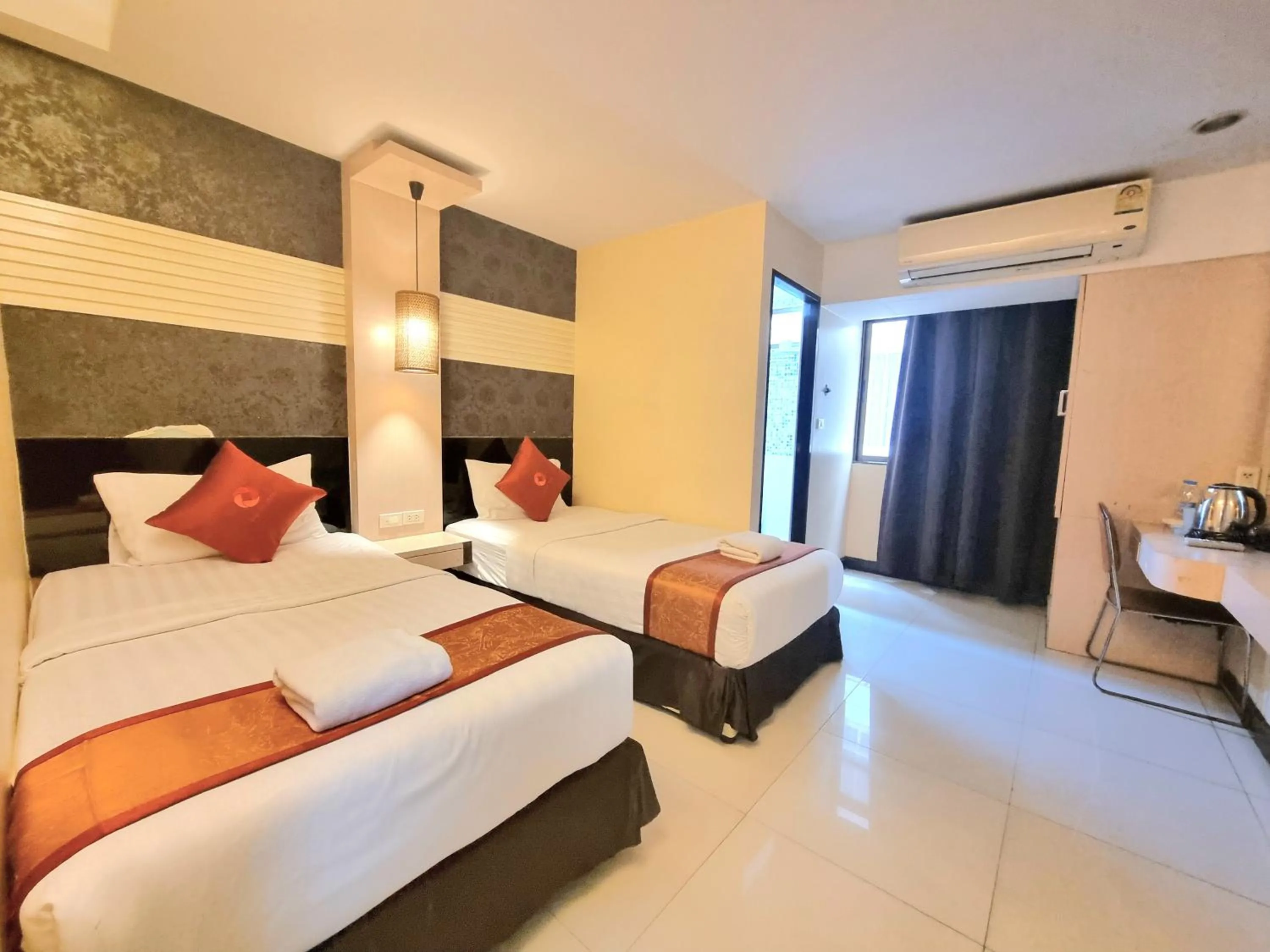 Bed in Cozi Inn Hotel, Bangkok