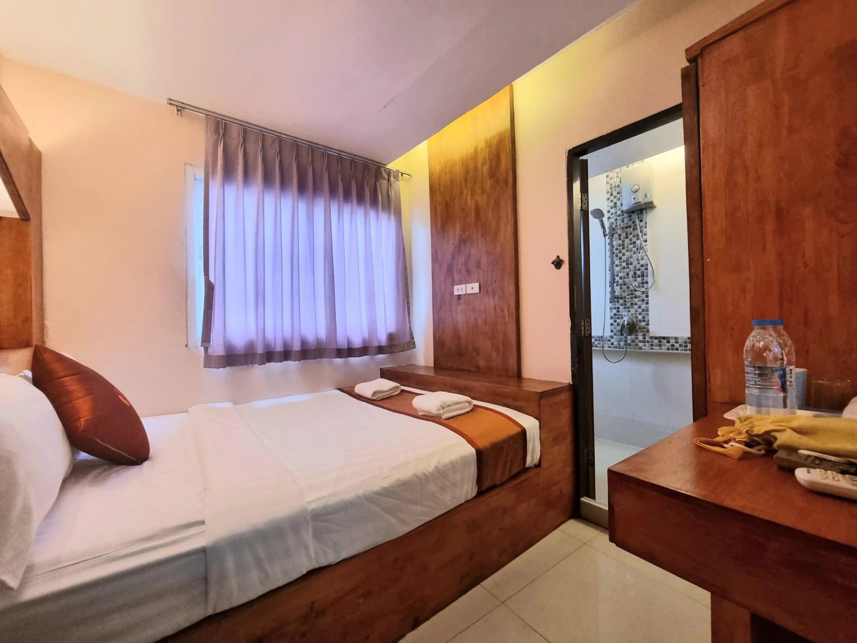 Bed in Cozi Inn Hotel, Bangkok