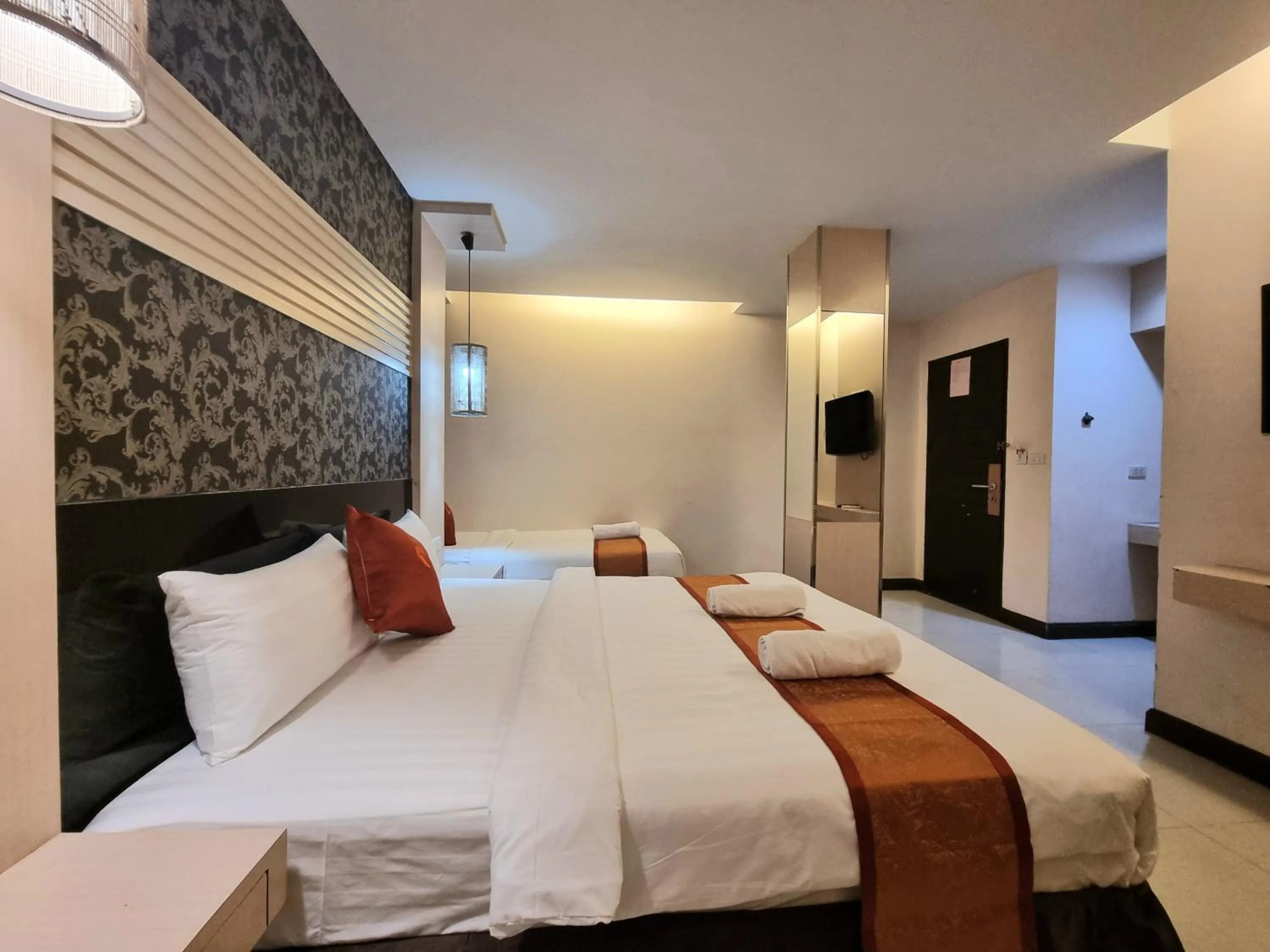 Bed in Cozi Inn Hotel, Bangkok