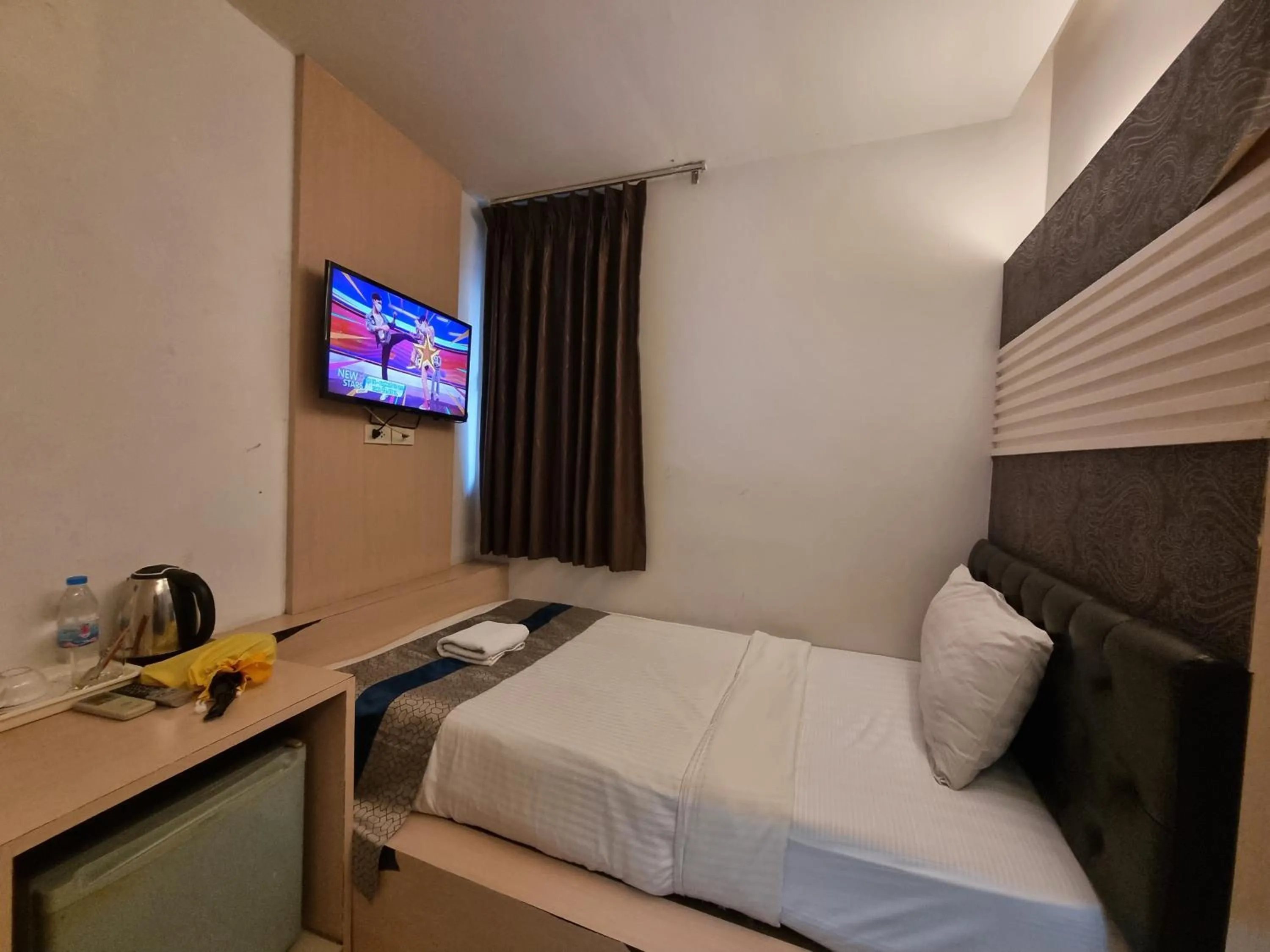 Bed in Cozi Inn Hotel, Bangkok