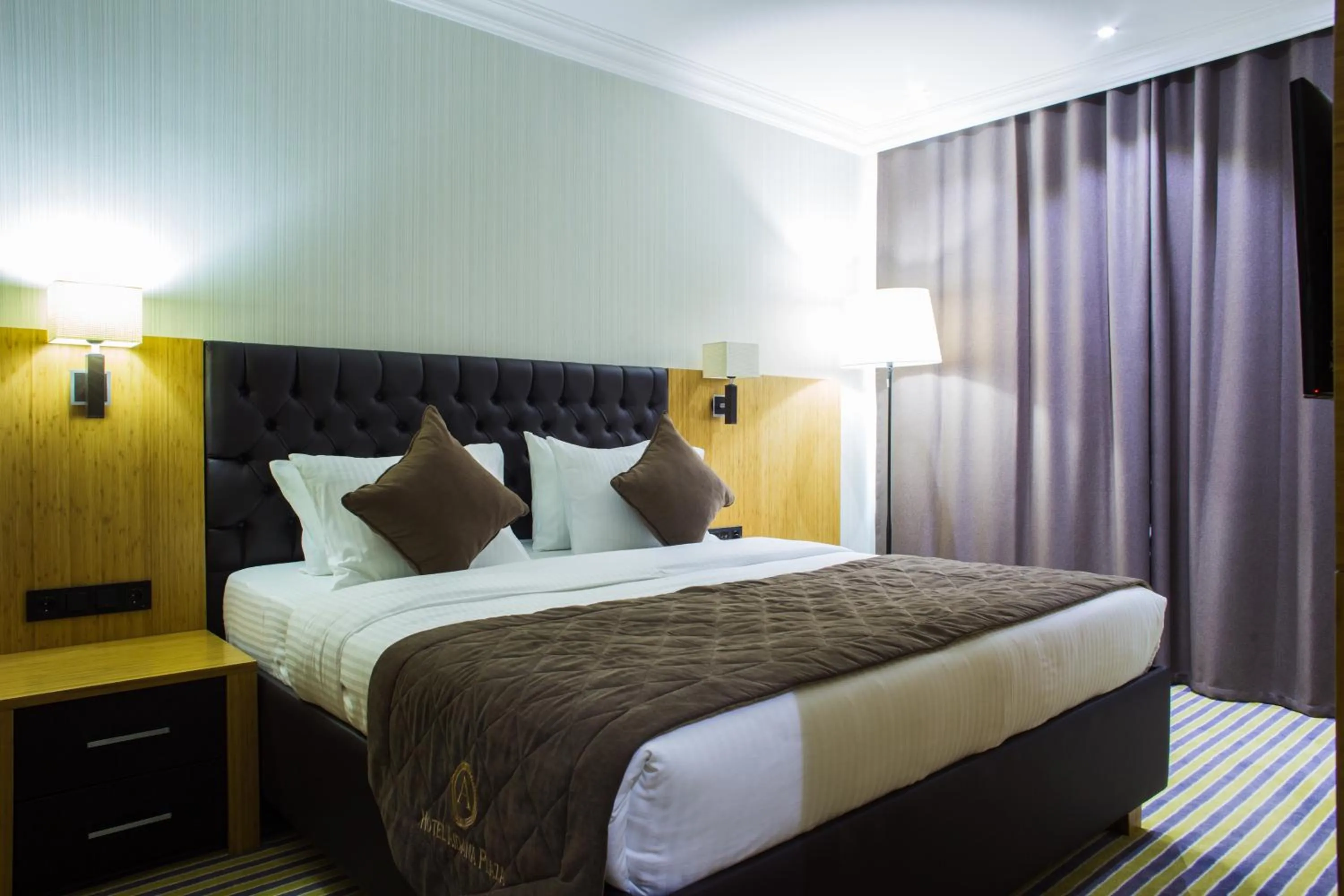 Bed in Aidana Plaza Hotel