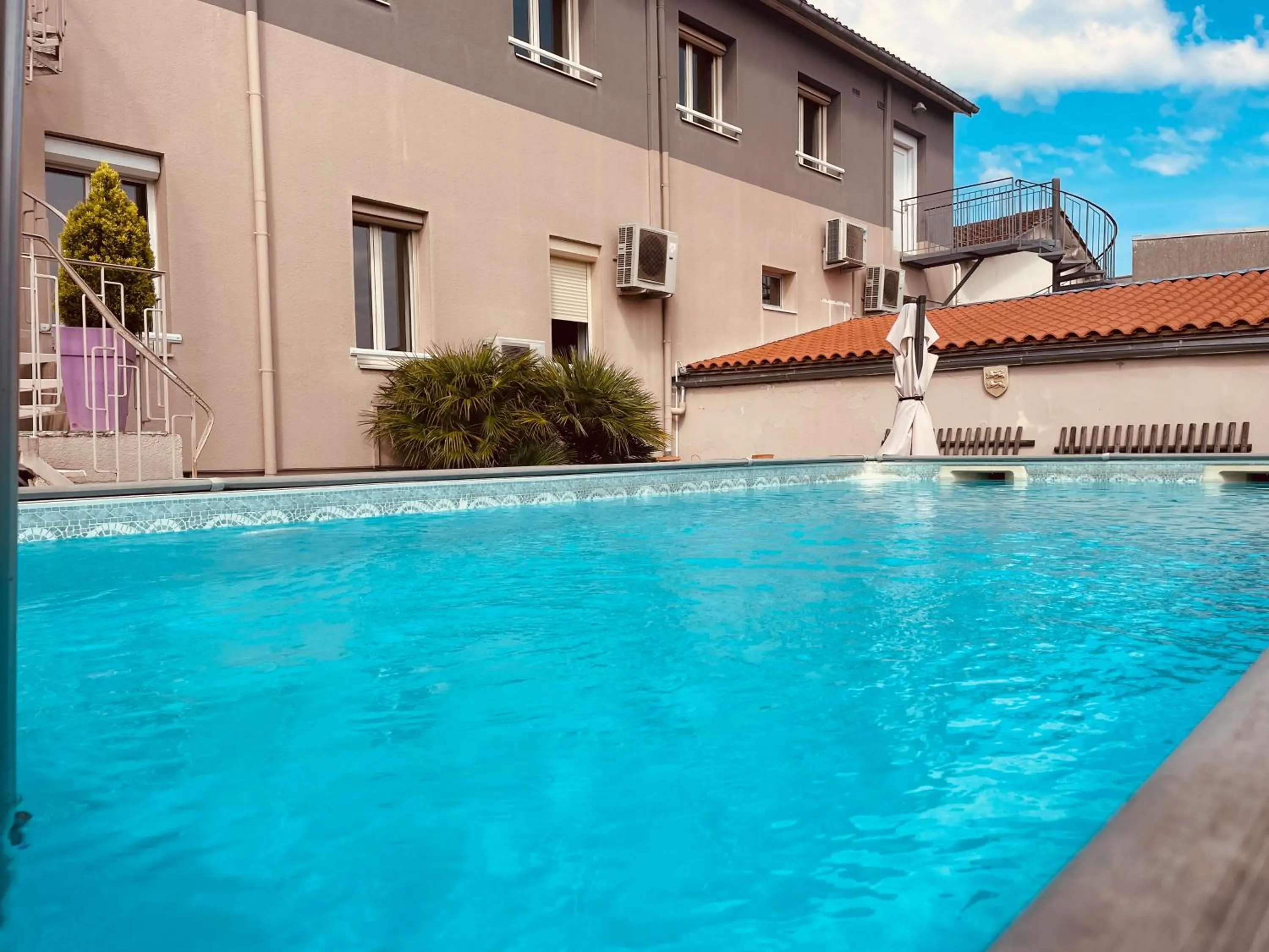 Swimming pool in Logis Le Passiflore Cognac