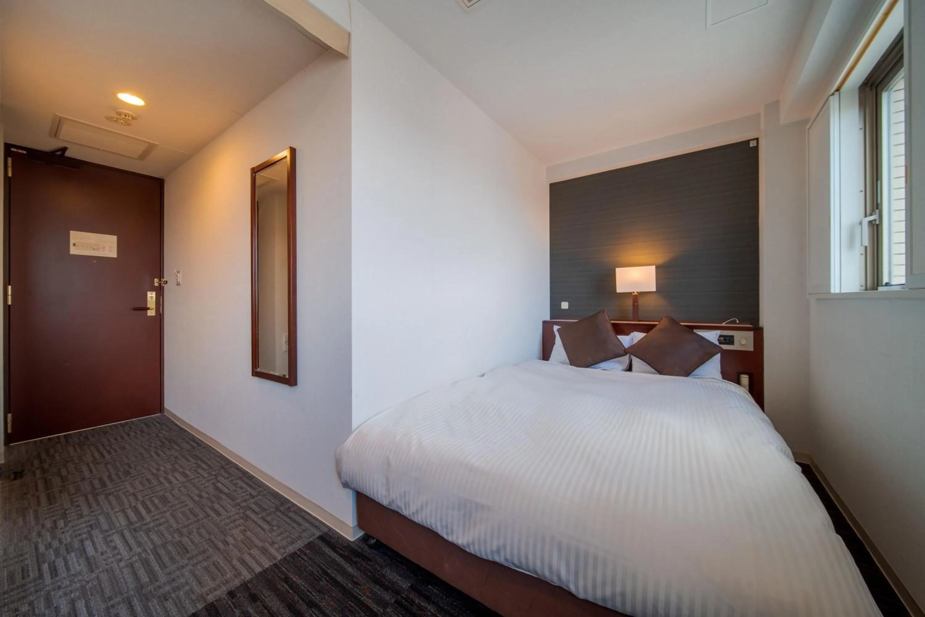 Bed in Meitetsu Inn Nagoya Ekimae