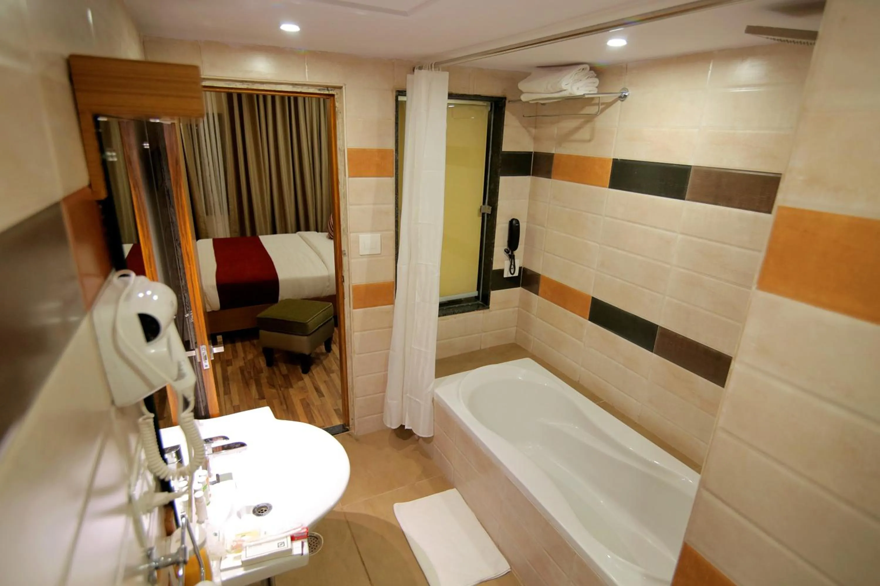 Bathroom, Bed in Hotel Hampi International