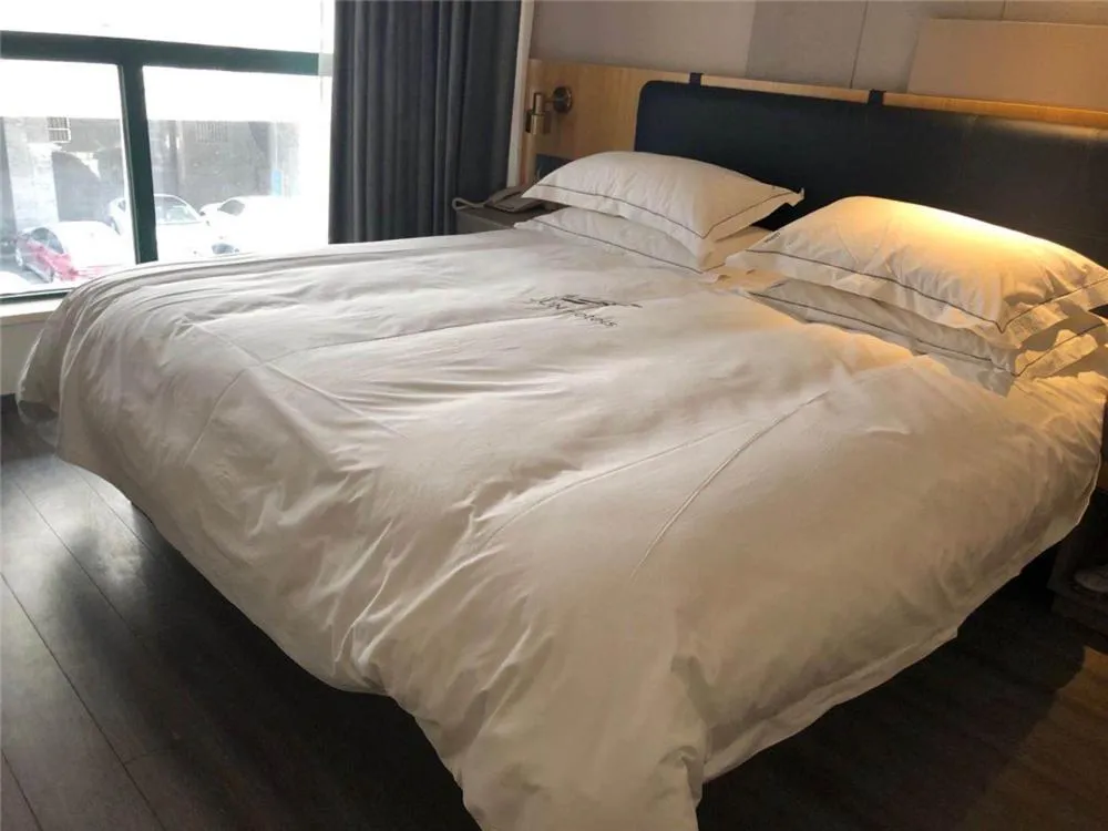 Bed in JUNYI Hotel Nanjing Olympic Sports Center
