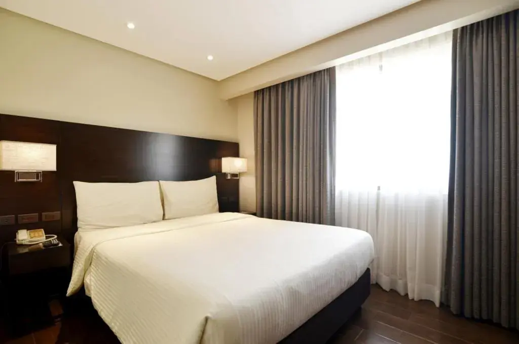 Bed in Pearl Garden Hotel Bed in Pearl Garden Hotel