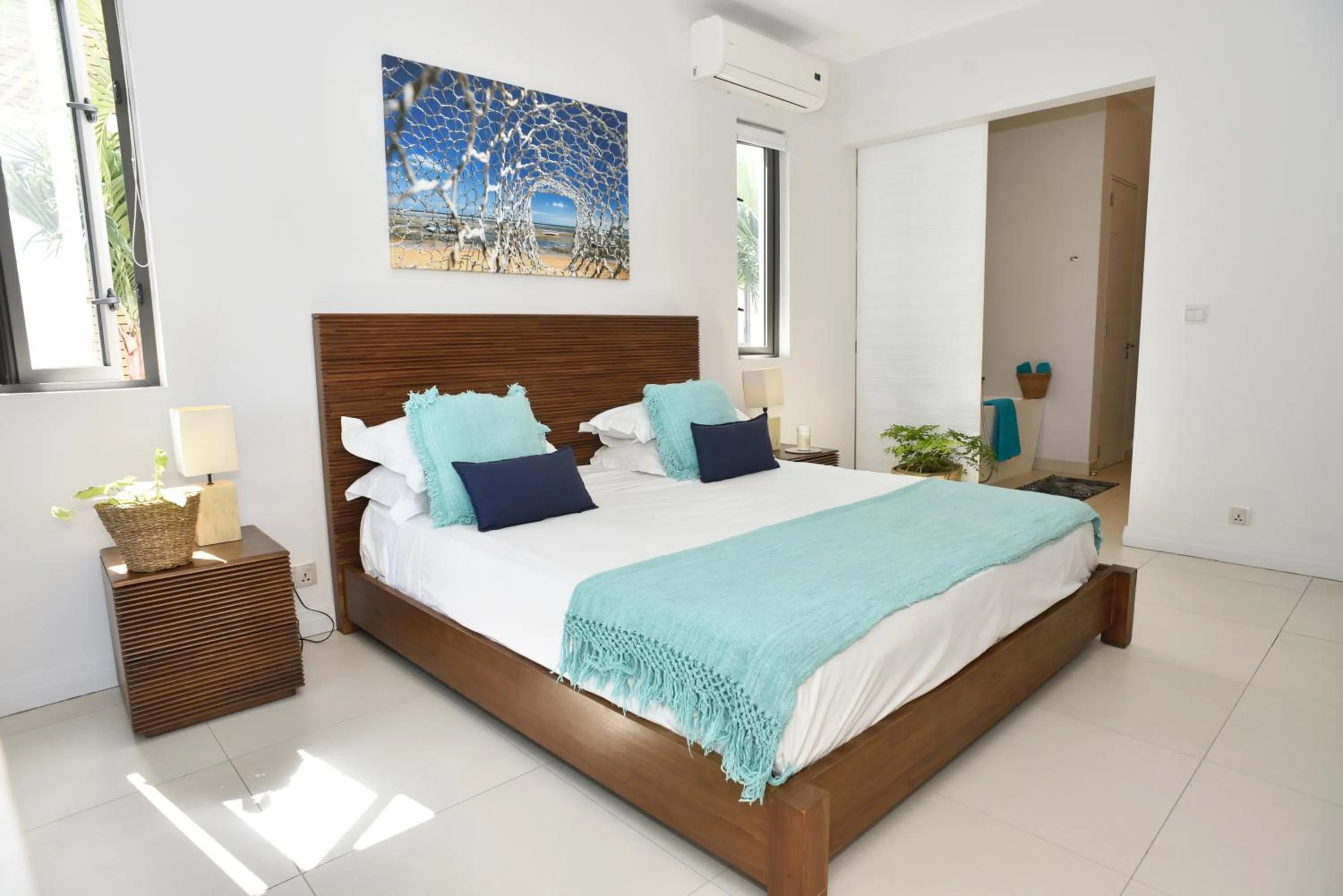 Bed in Cap Ouest Beachfront Luxury Penthouse & Apartment