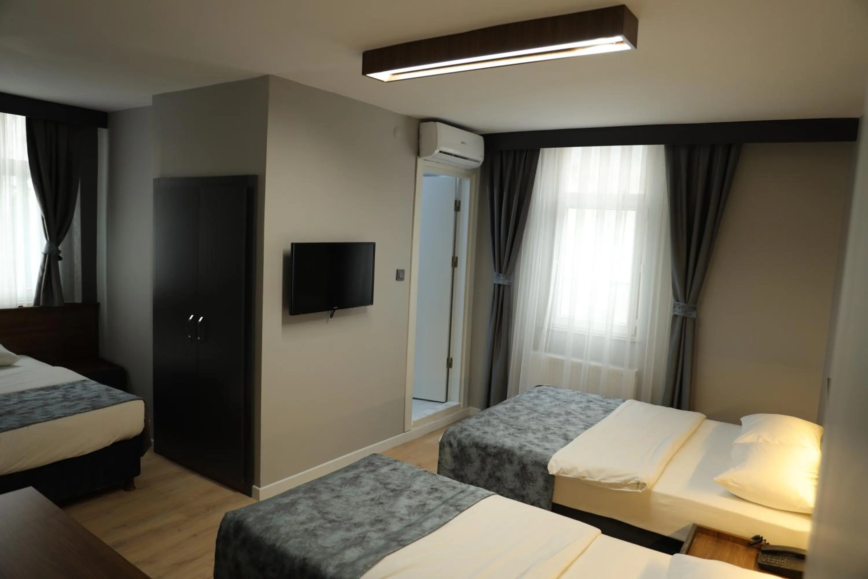 Communal lounge/ TV room, Bed in Turkuaz Hotel