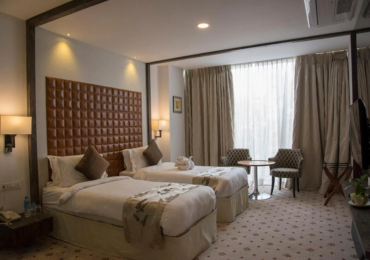 Photo of the whole room, Bed in Regenta Central Hotel & Convention Centre Nagpur