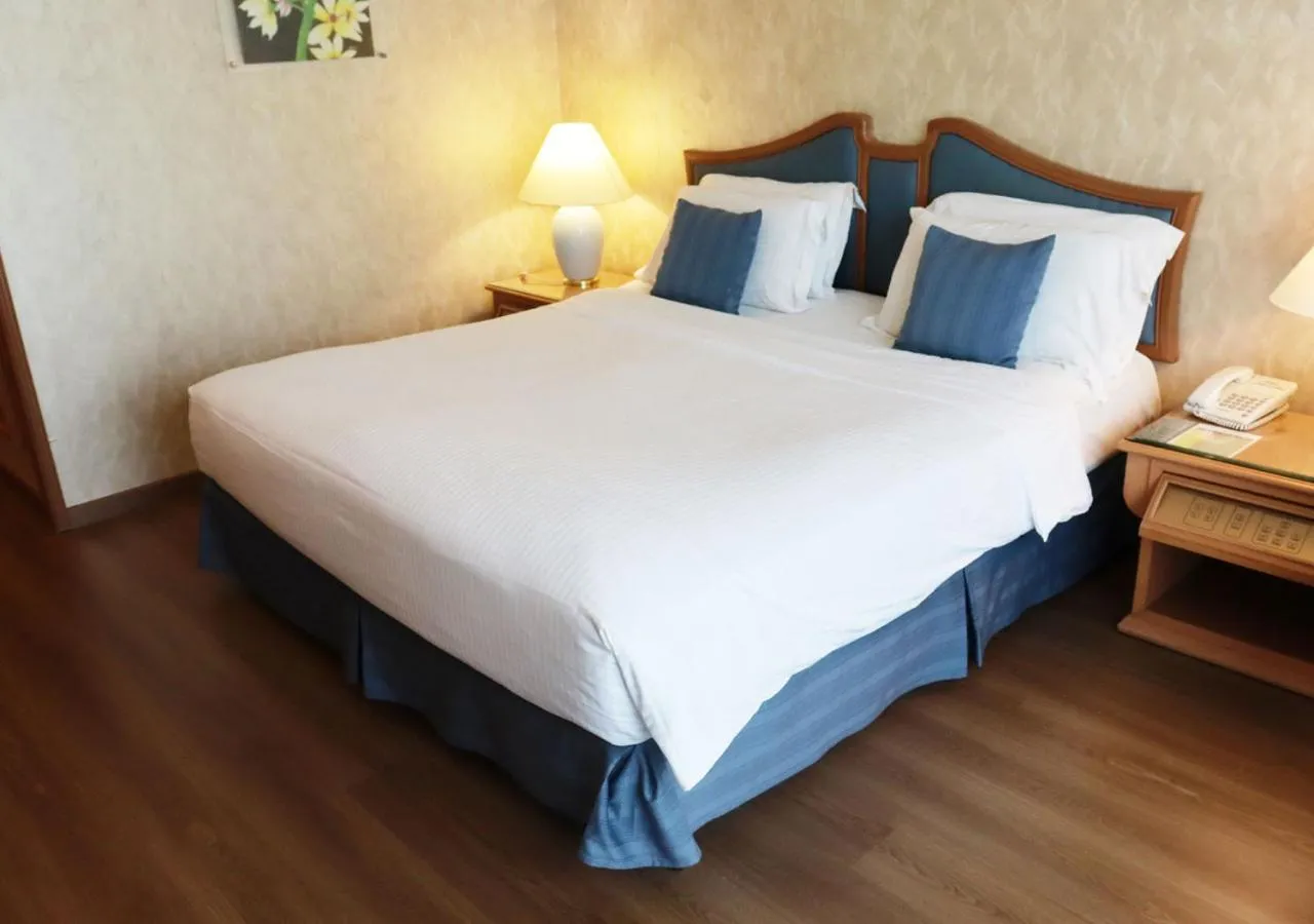 Bed in Grand Palace Hotel