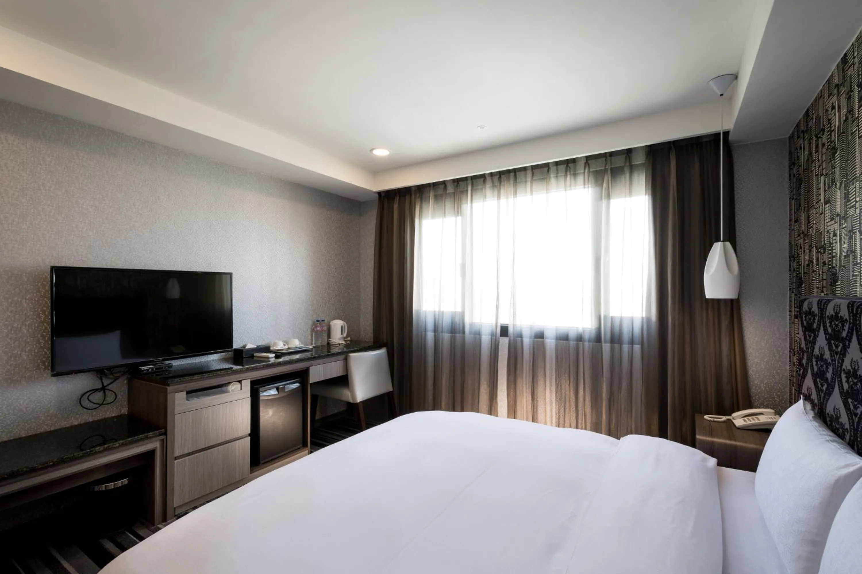 Bed in JUNG-ZAW BUSSINESS HOTEL