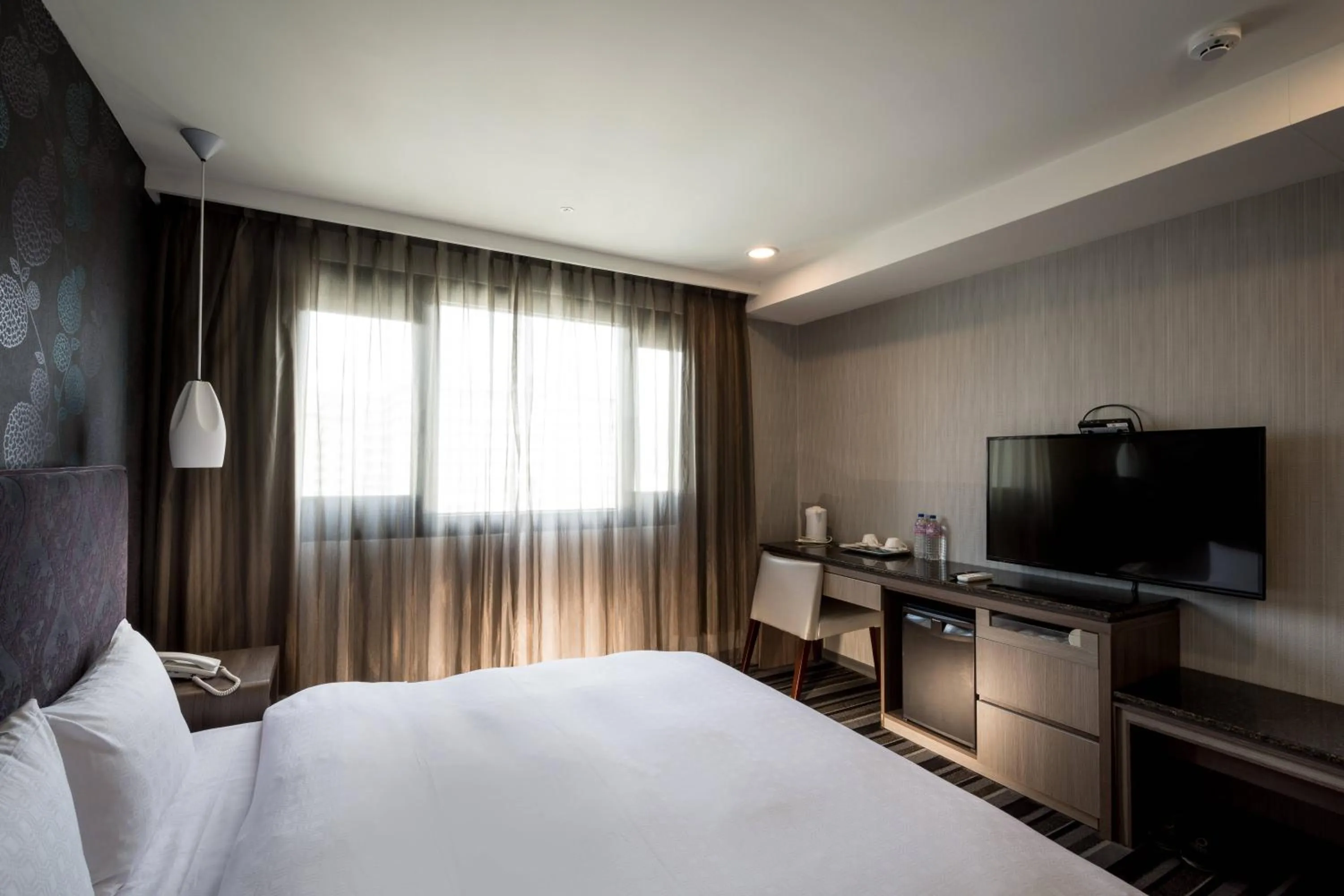 Bed in JUNG-ZAW BUSSINESS HOTEL