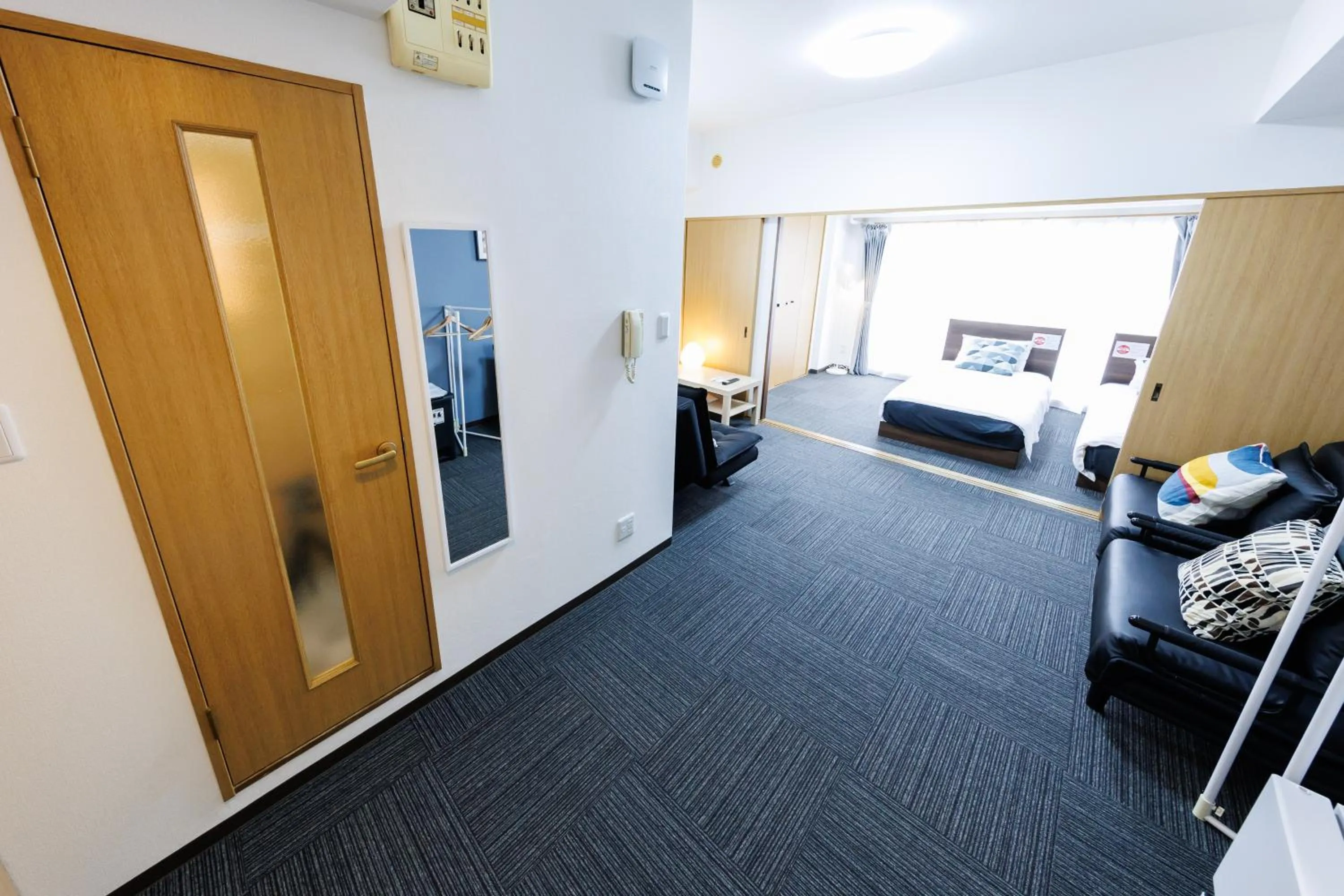 Bed in Grande Famille Shimanouchi Dotonbori Condo