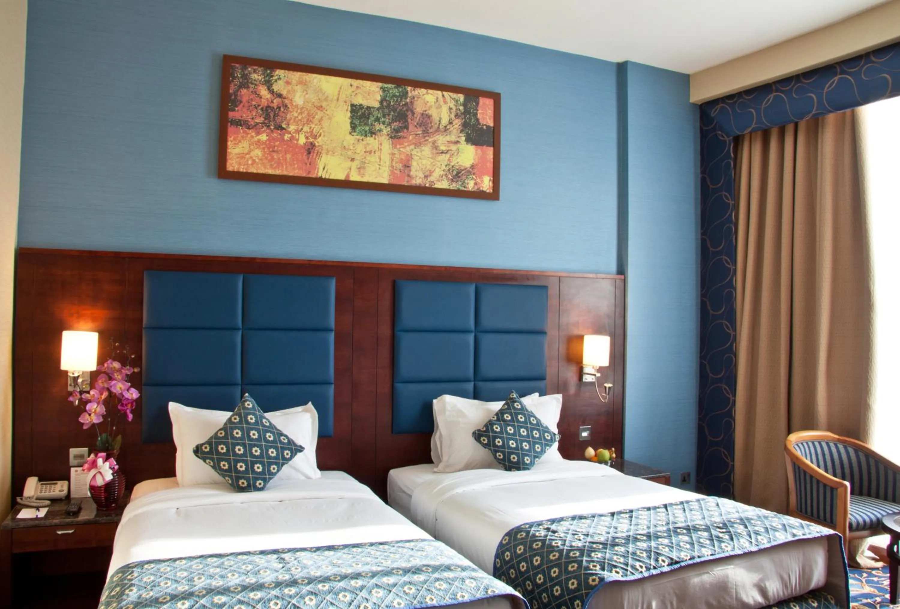 Bed in Ramee Rose Hotel