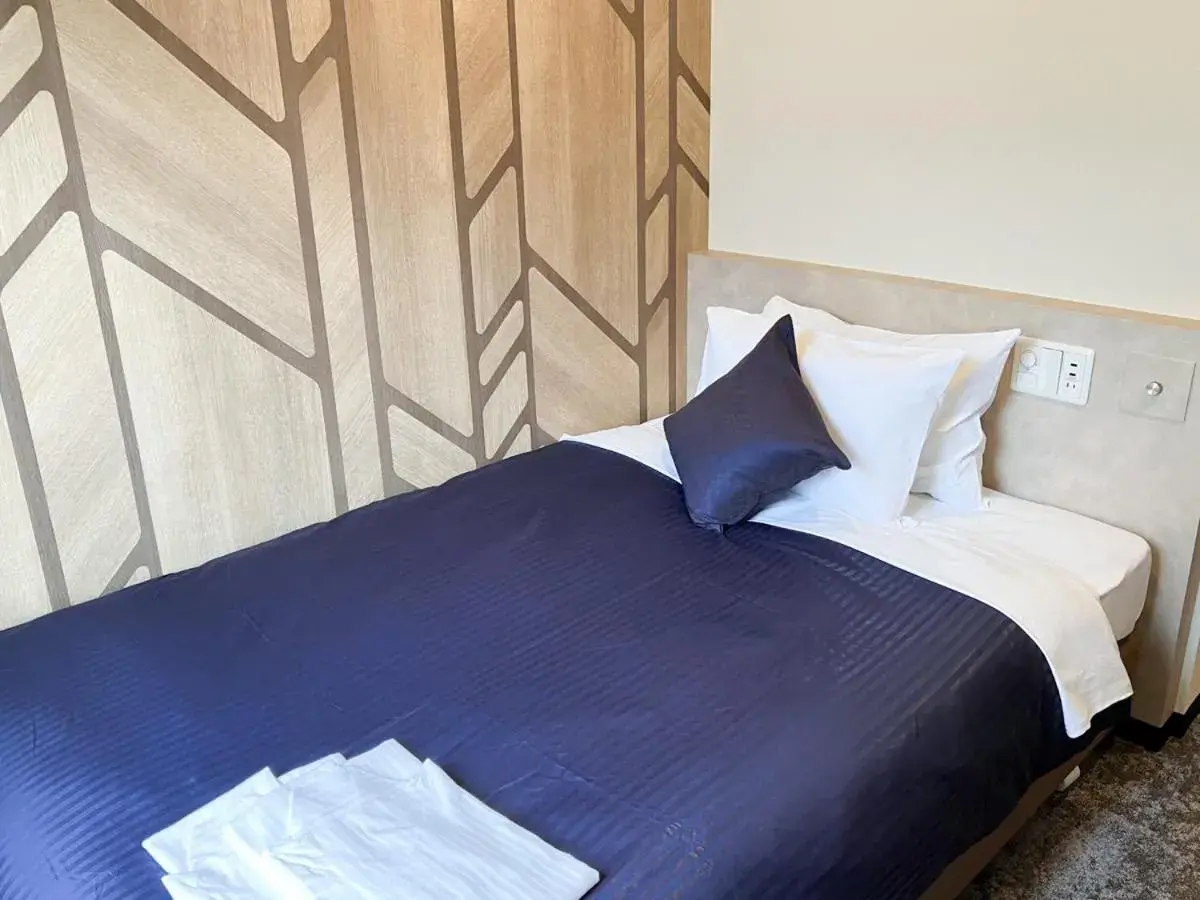 Bed in HOTEL LiVEMAX BUDGET Hiratsuka Ekimae Bed in HOTEL LiVEMAX BUDGET Hiratsuka Ekimae