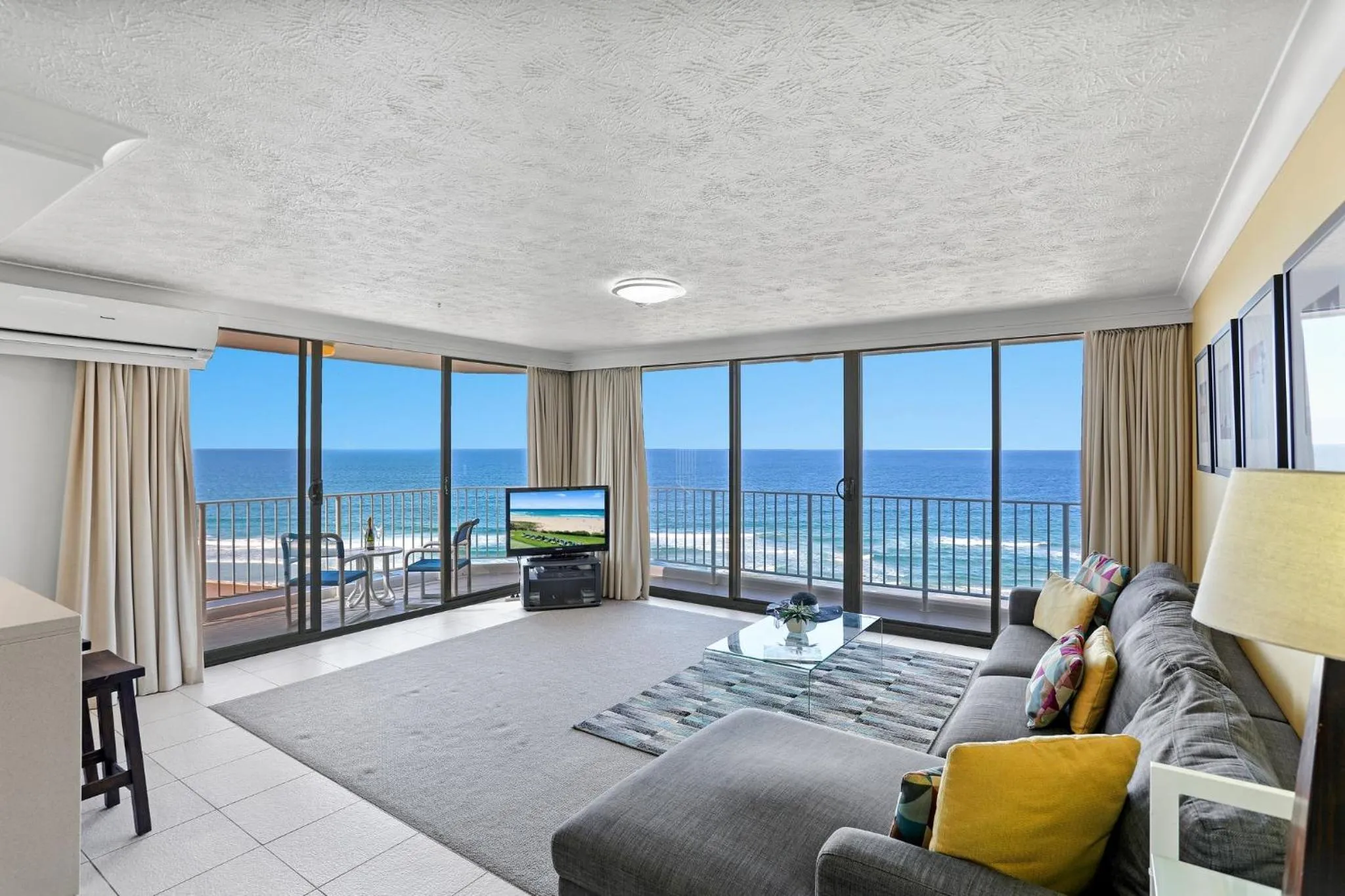 Living room, Bed in Breakers North Absolute Beachfront Apartments - Official
