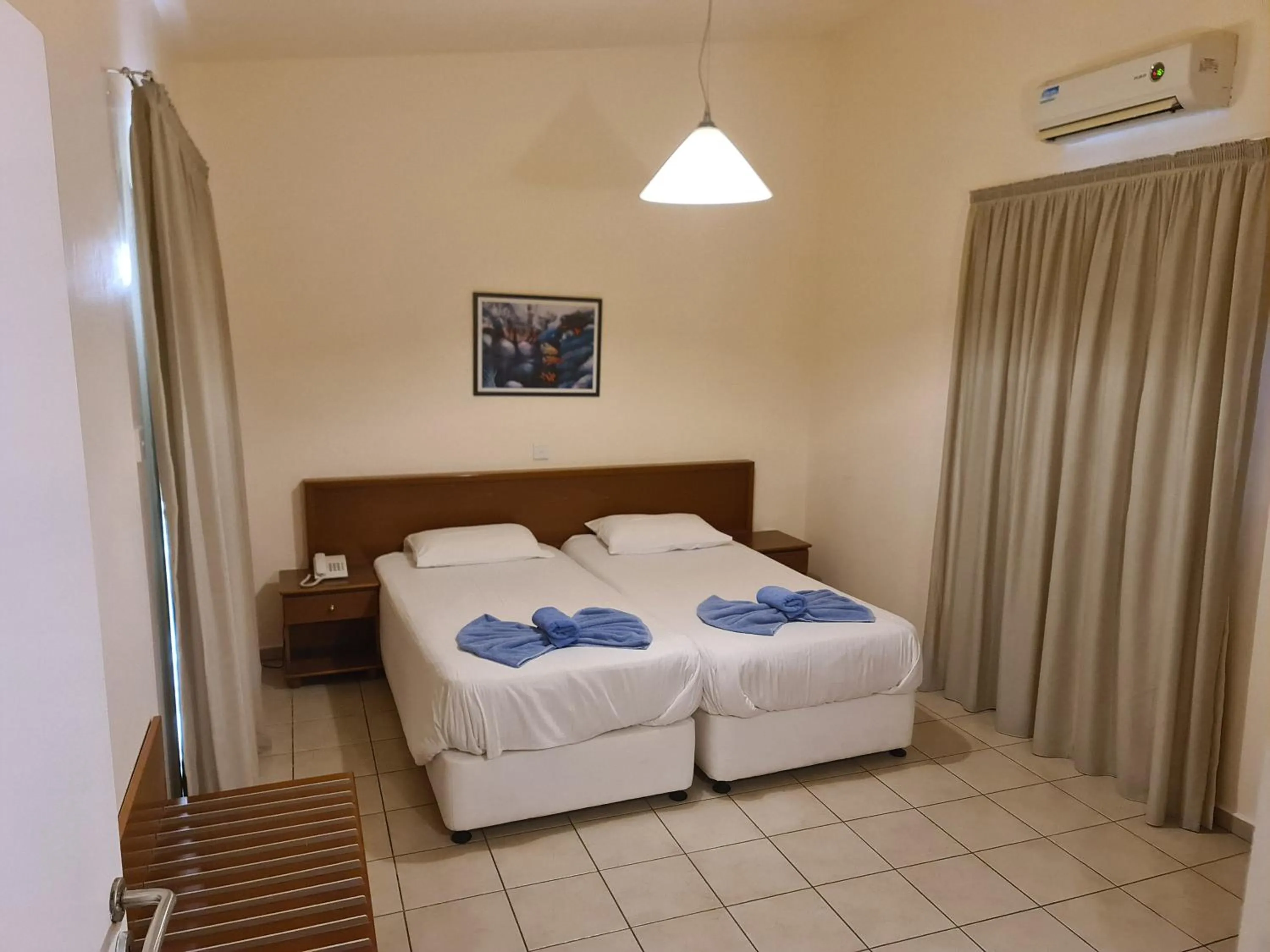Bed in Nissiana Hotel & Bungalows