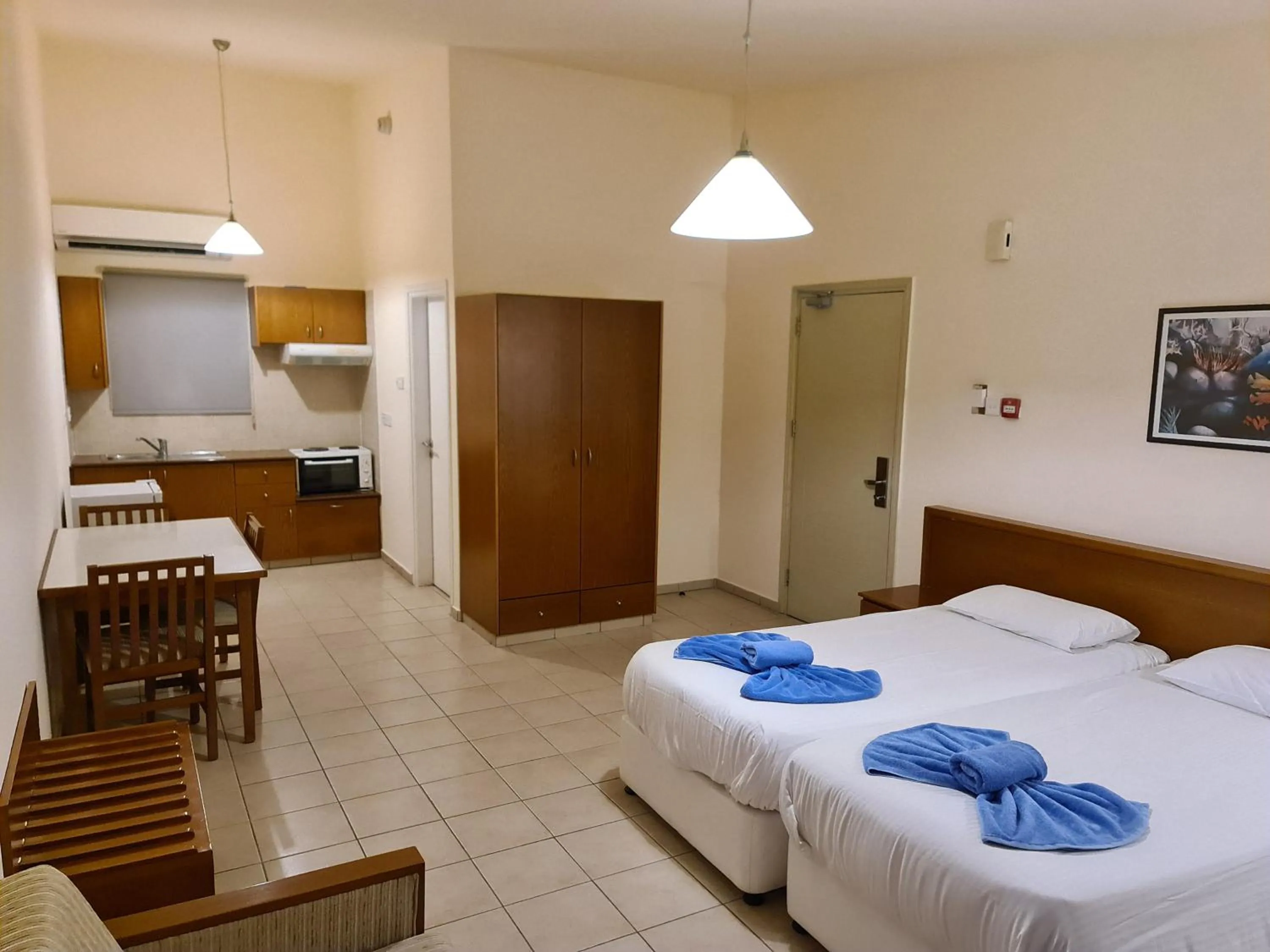 Kitchen or kitchenette, Bed in Nissiana Hotel & Bungalows